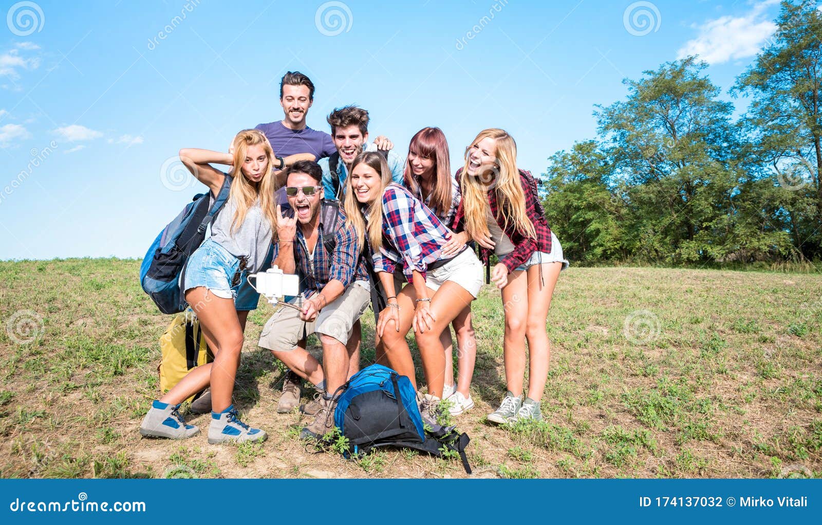 friends group taking selfie at trekking excursion - happy friendship and freedom concept with young millenial people having fun