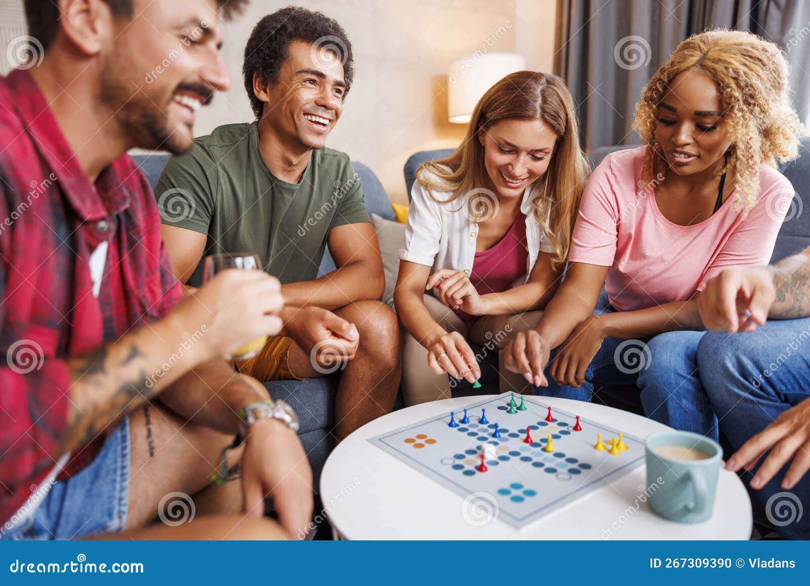 Friends Having Fun Playing Ludo Board Game while Spending Leisure