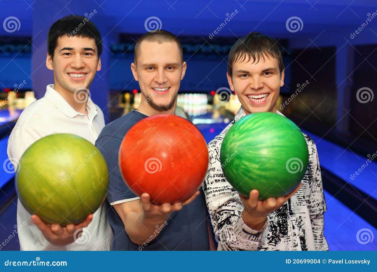 friends stand alongside and hold balls for bowling