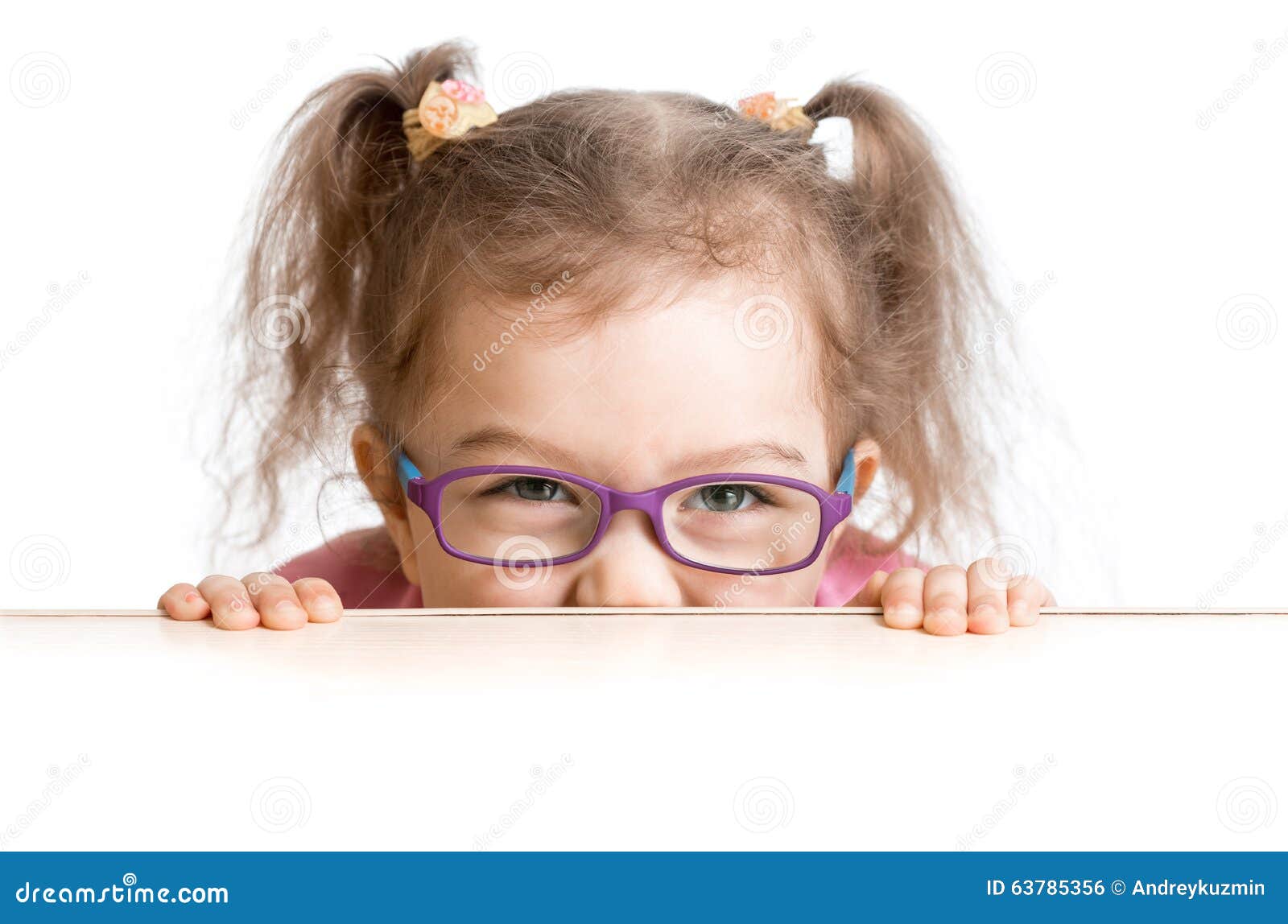 frightened kid in spectacles looking from under