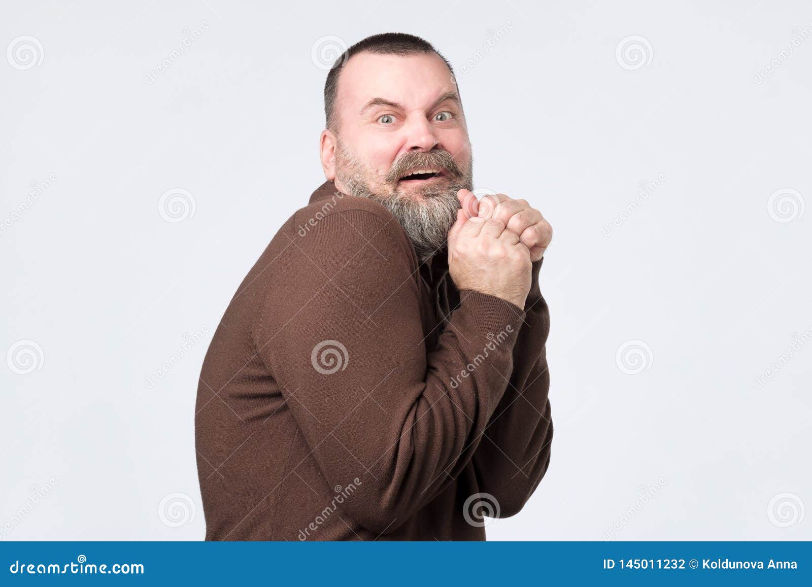 frightened mature man with expression of fear on face.