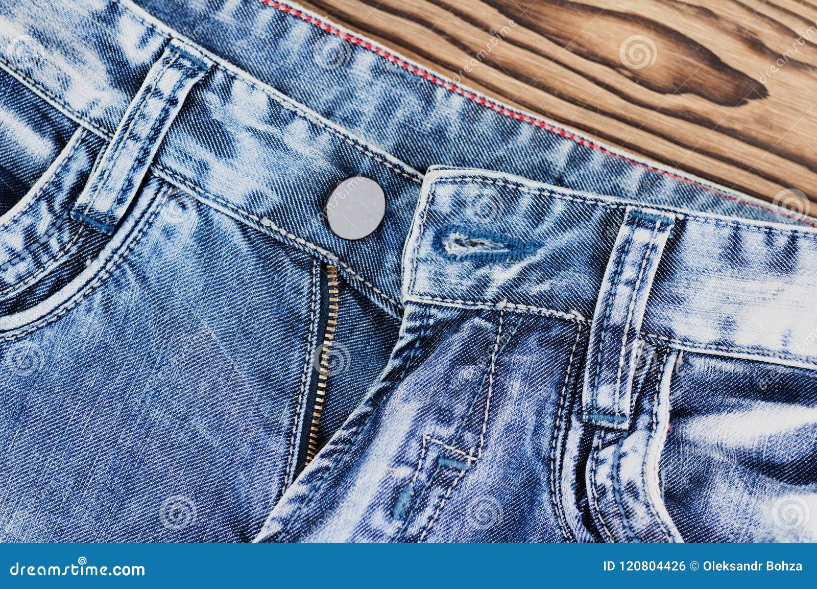 Front Empty Pockets and Unbuttoned Zipper on Blue Jeans Stock Photo