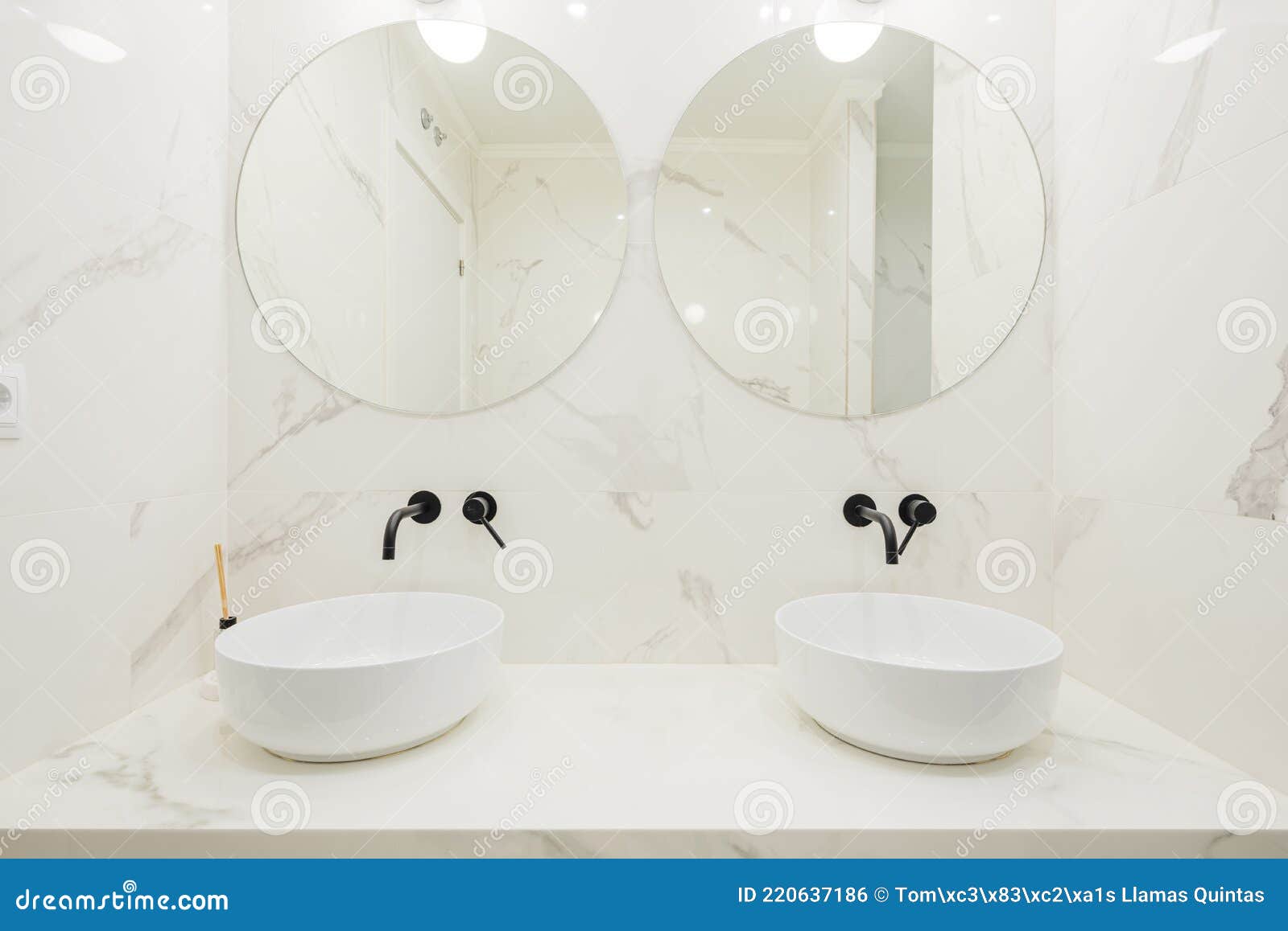 Front Image of Sink and Twin Mirrors in Bathroom with Marble Masonry
