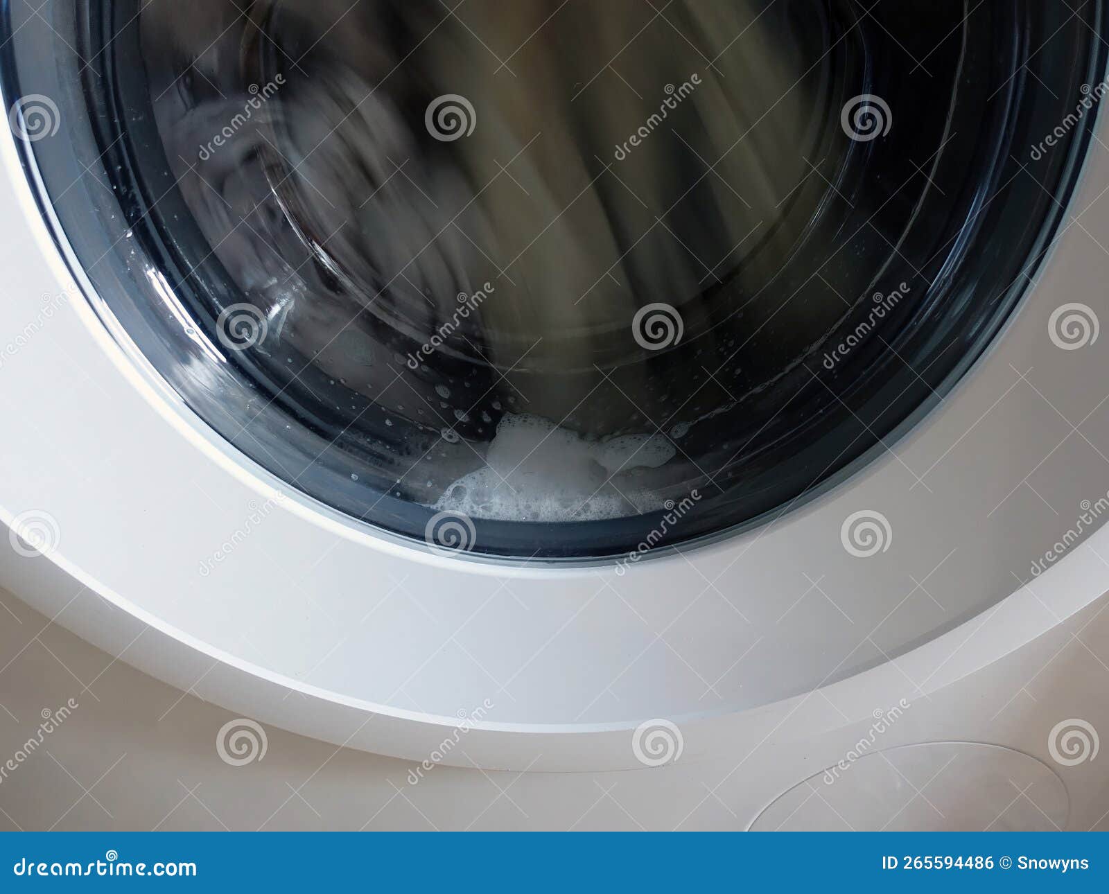 A Front Loading Washing Machine with Soap, Spinning Laundry Clothing
