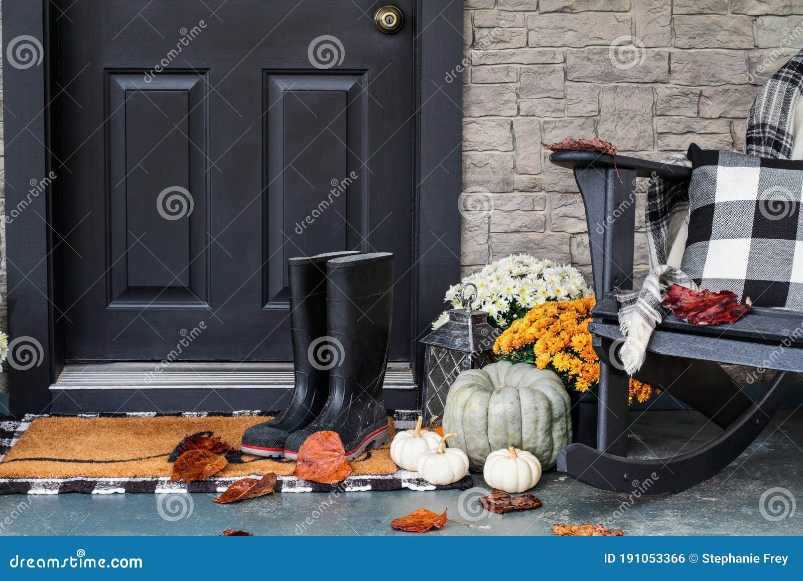 front porch decorated for autumn with buffalo plaid