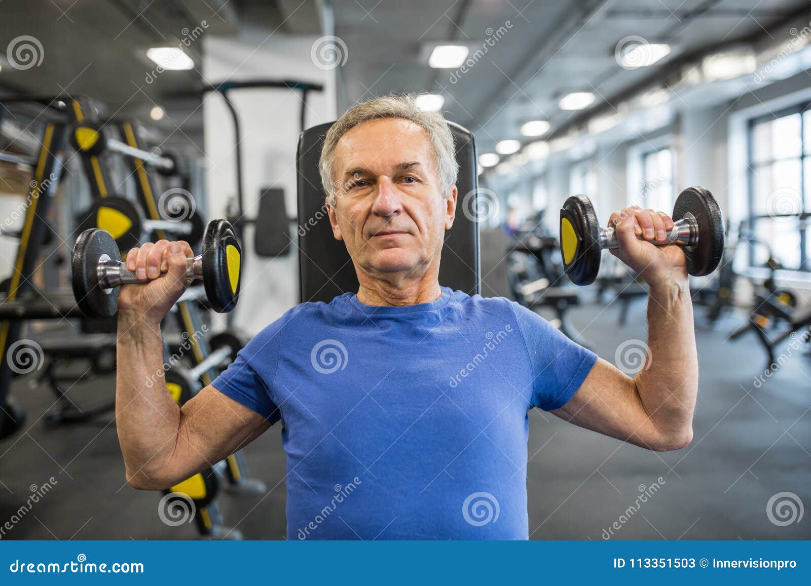 Senior Man Lifting Dumbbells on Hammer Strength Machine Stock Image ...