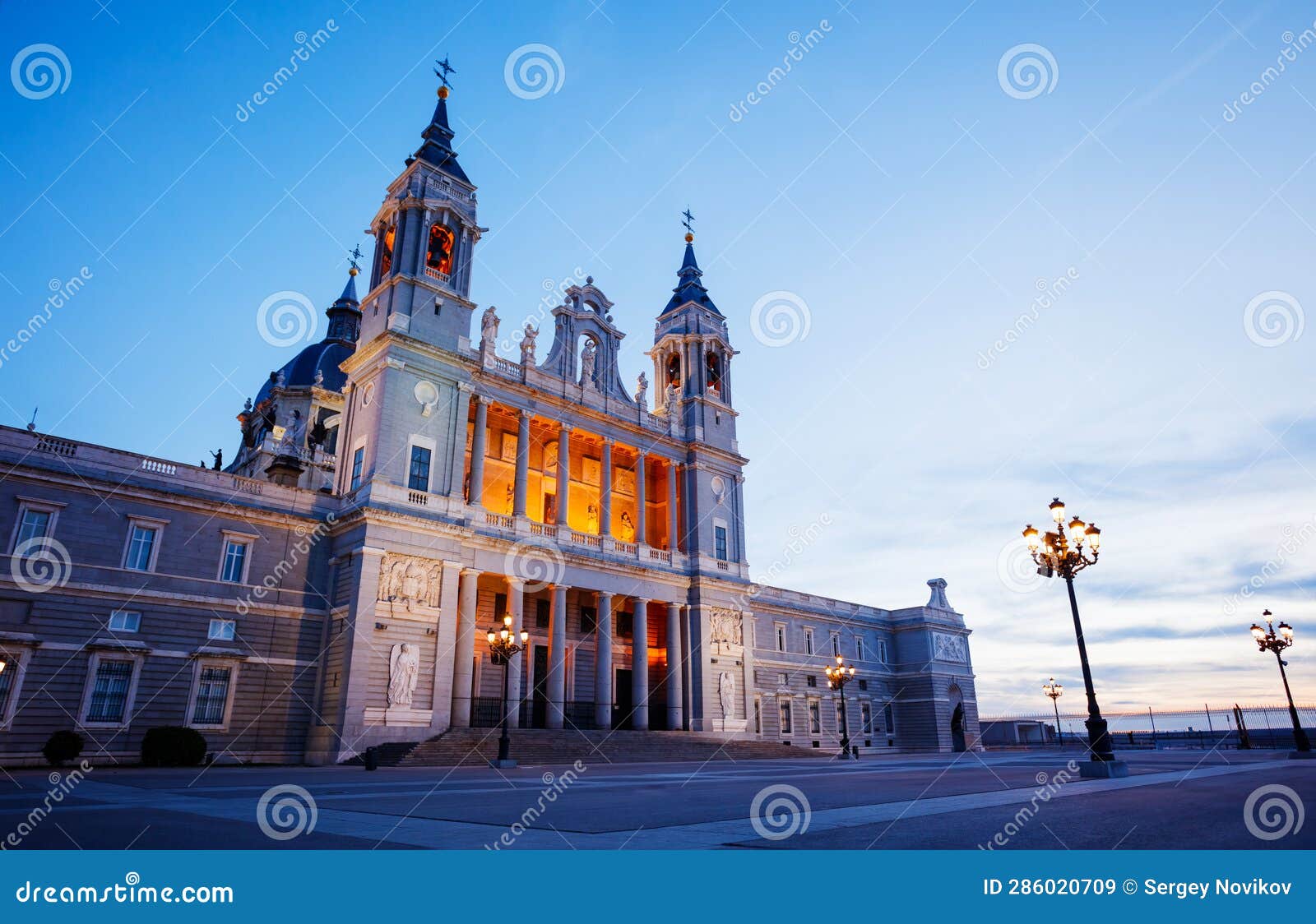 almudena cathedral illuminated during dusk at armeria square