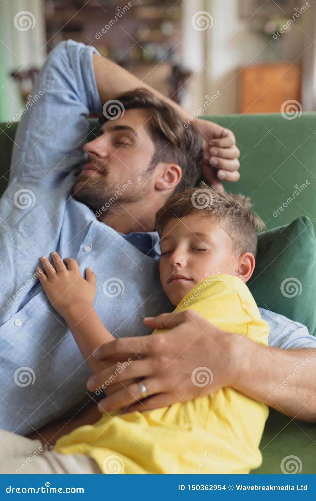 Father and Son Sleeping Together on a Sofa in Living Room Stock ...