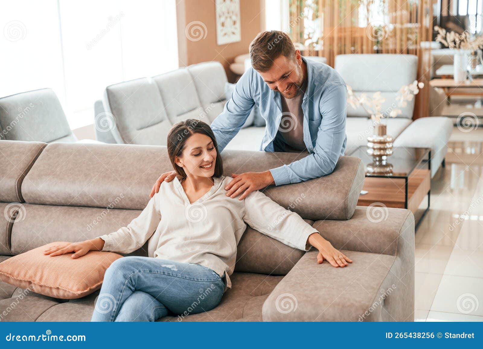 Front View. Couple Choosing the Sofa and Bed in the Store Stock Photo
