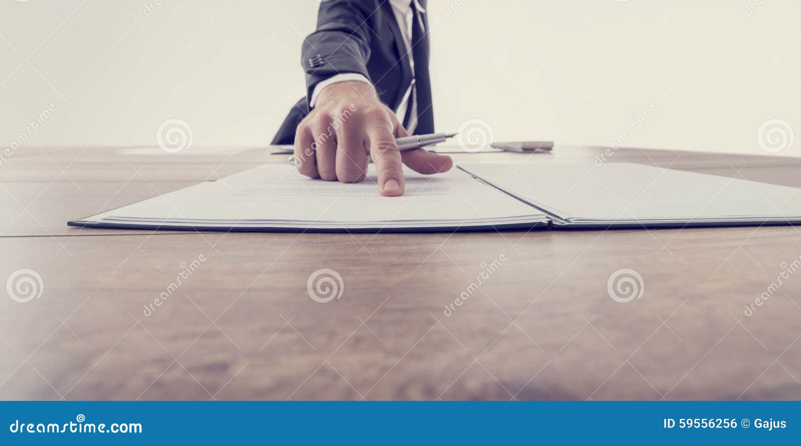front view of employer pointing to a contract