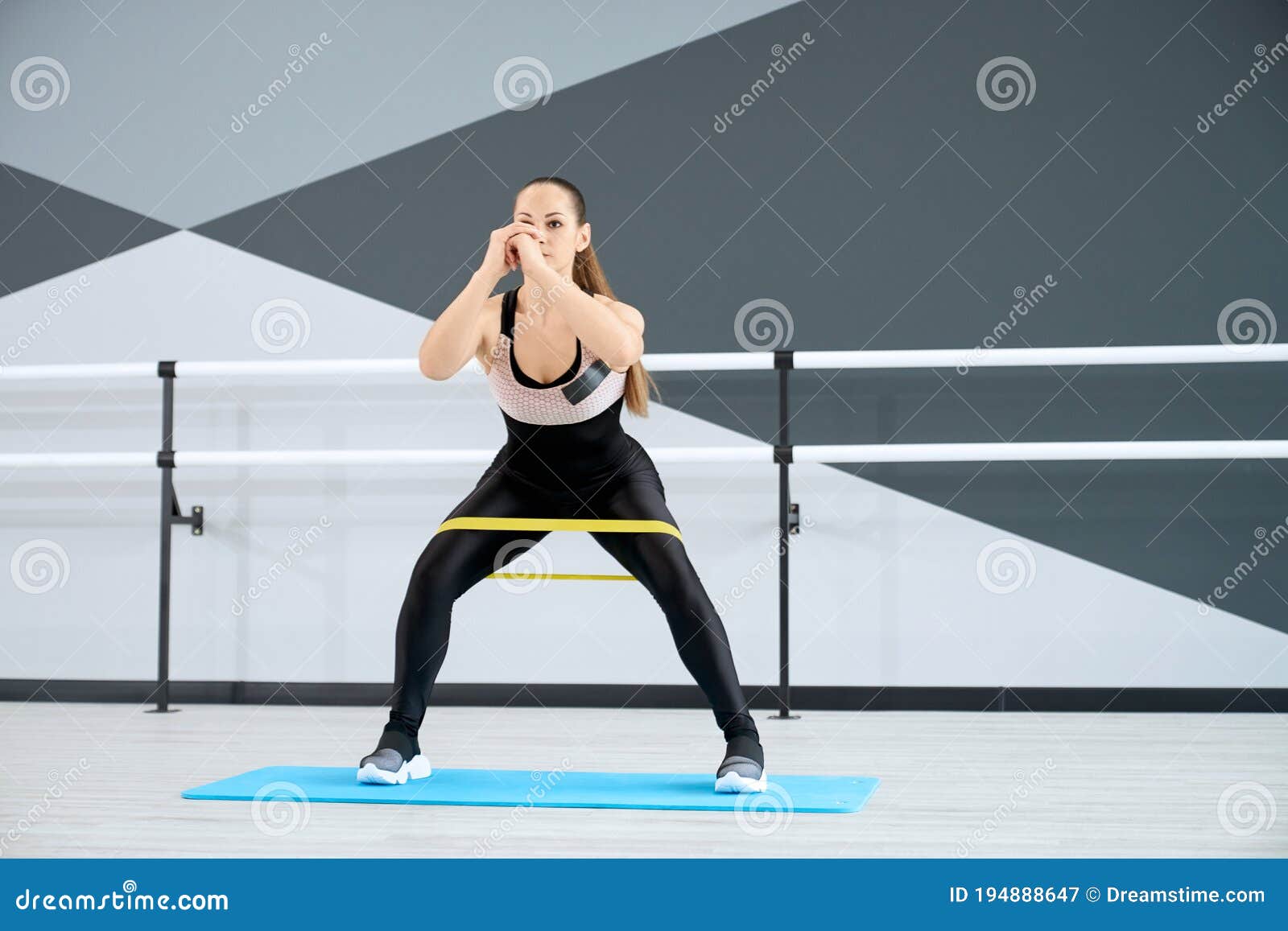 Woman Training Legs Using Fitness Band. Stock Image - Image of