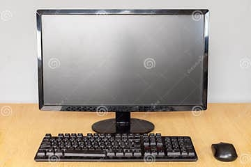 Front View of a Modern Desktop Computer Setup with Monitor, Keyboard