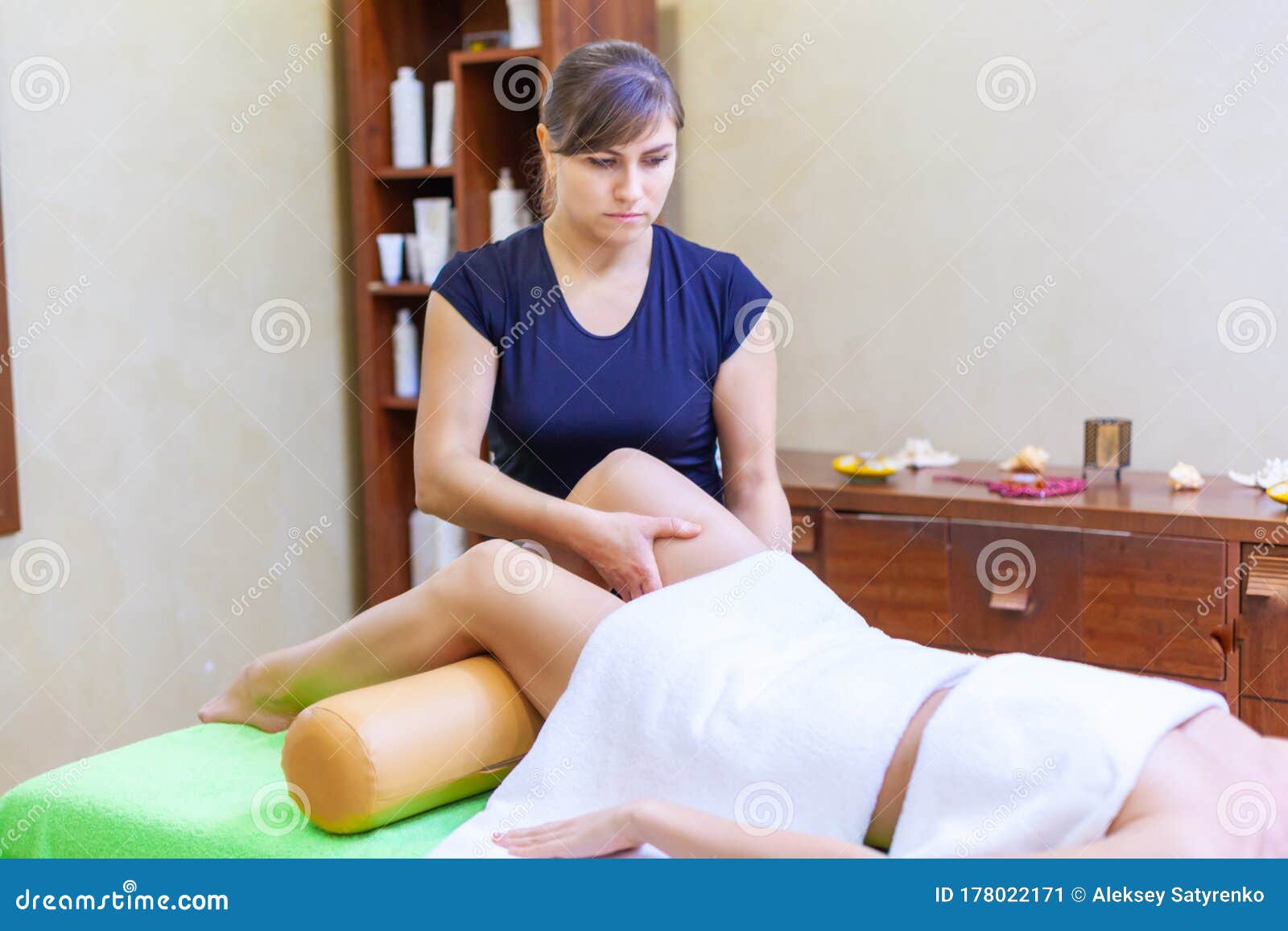 Front View Of Professional Massage Therapist Giving Massage On Woman