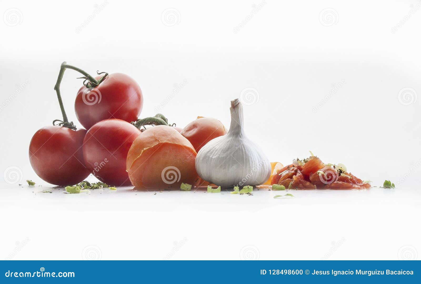 front view of several tomatoes on a branch, a garlic and chive