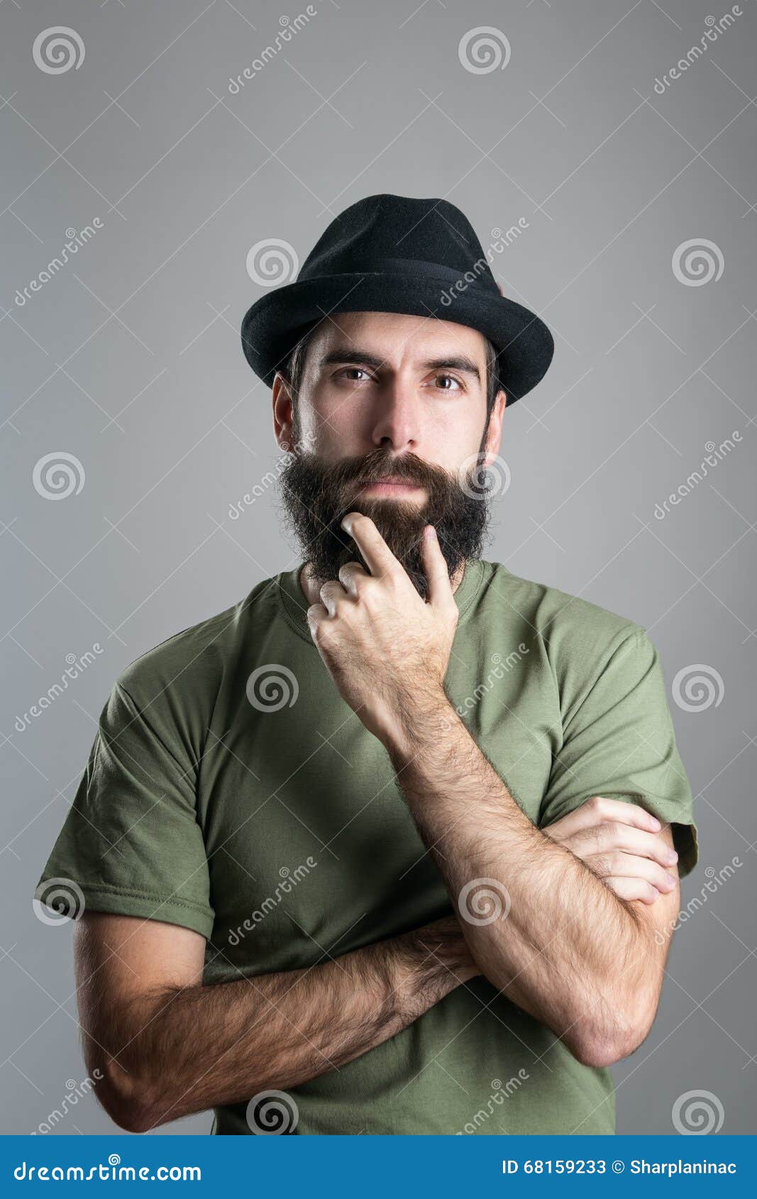 Front View of Thoughtful Man Stroking His Beard Looking at Camera Stock