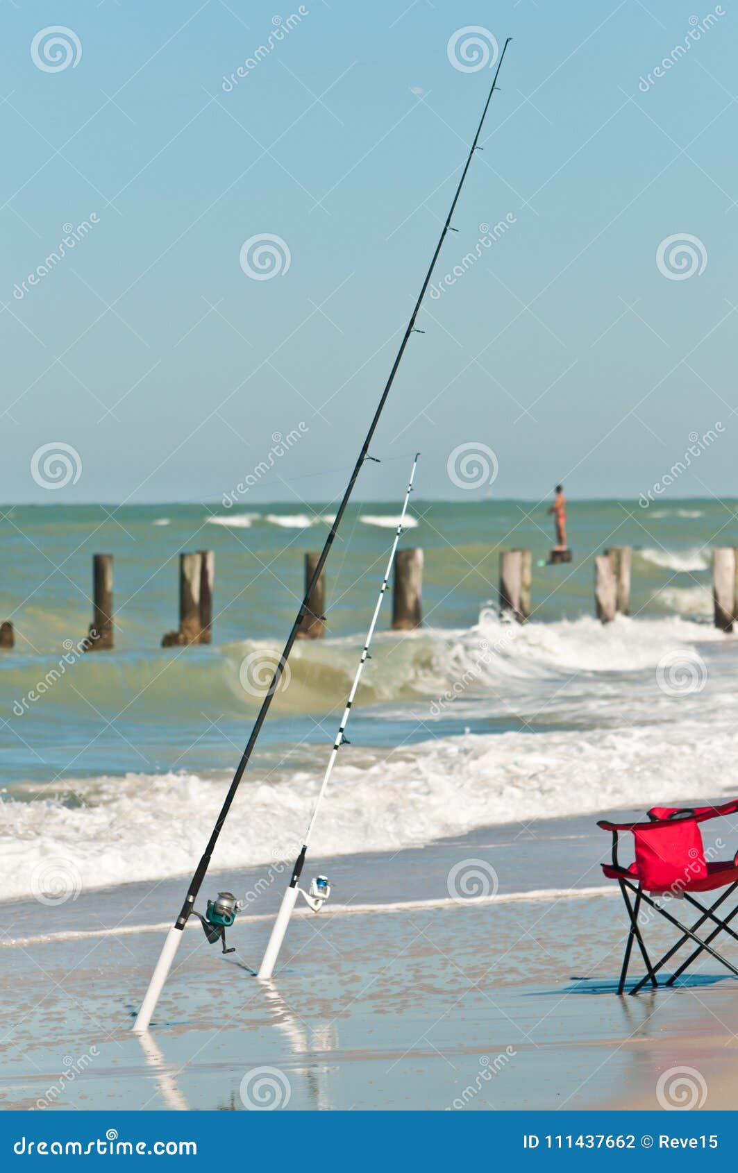 Front View of a Tropical Beach Surf Zone and Two Surf Fishing Rods