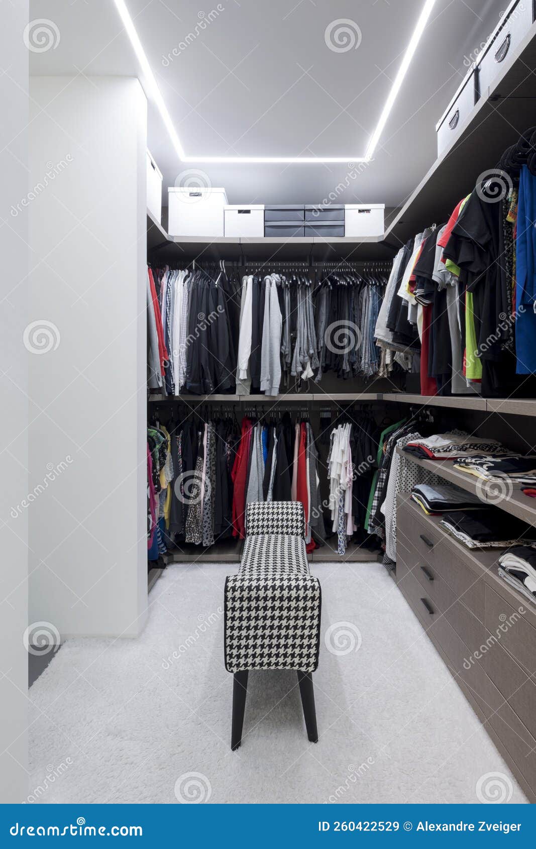Front View Walkin Closet Full of Clothes and in the Center is a