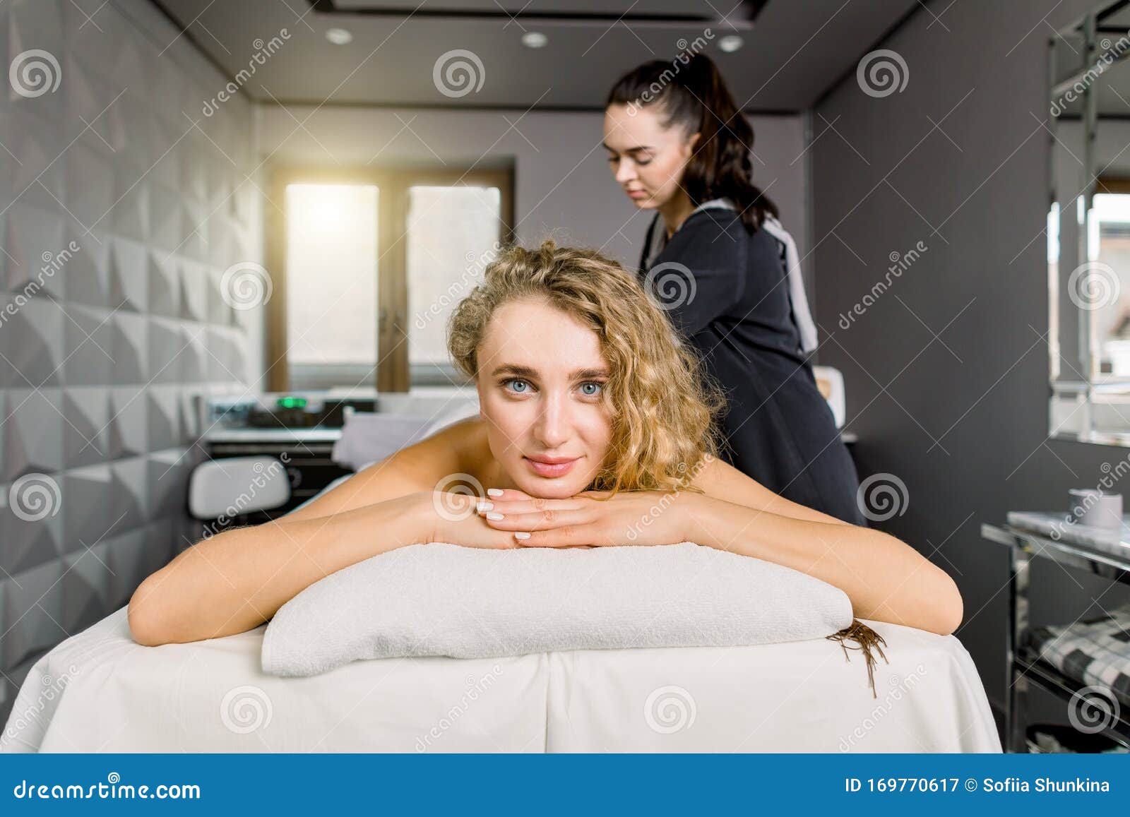 Front View Of Young Female Client Enjoying Relaxing Full Body Massage