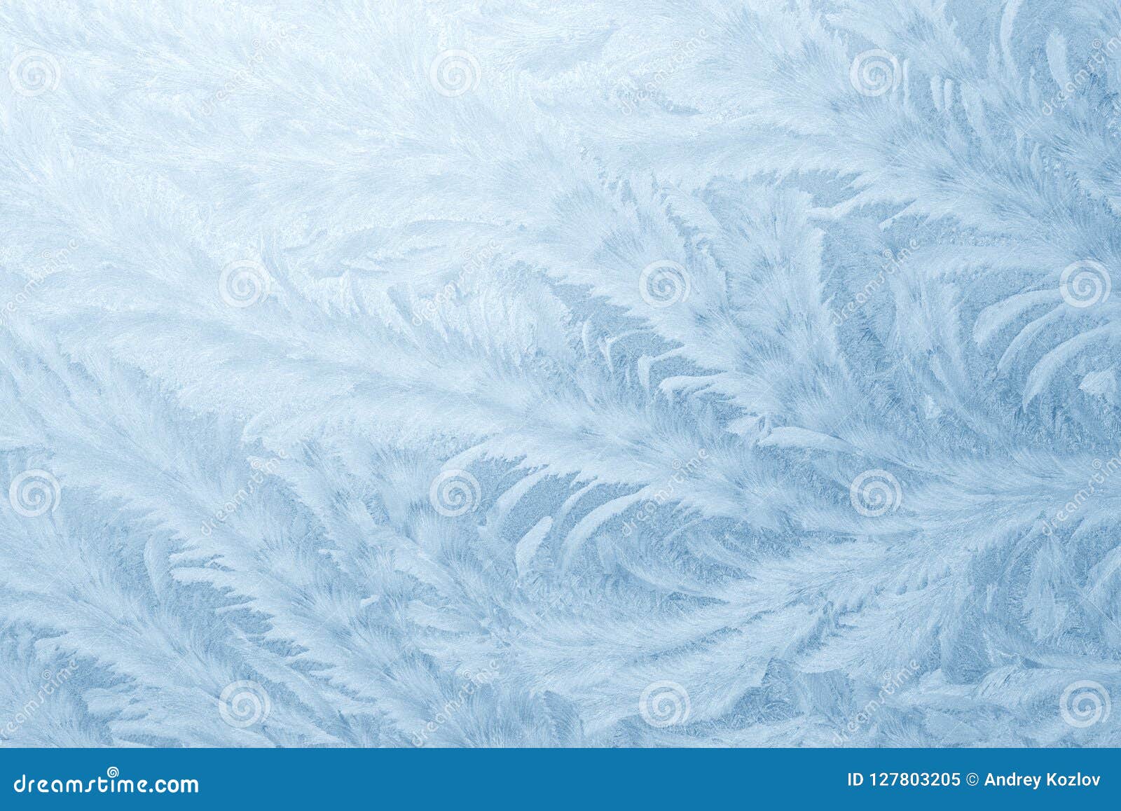 frost patterns on window glass in winter season. frosted glass texture. blue background