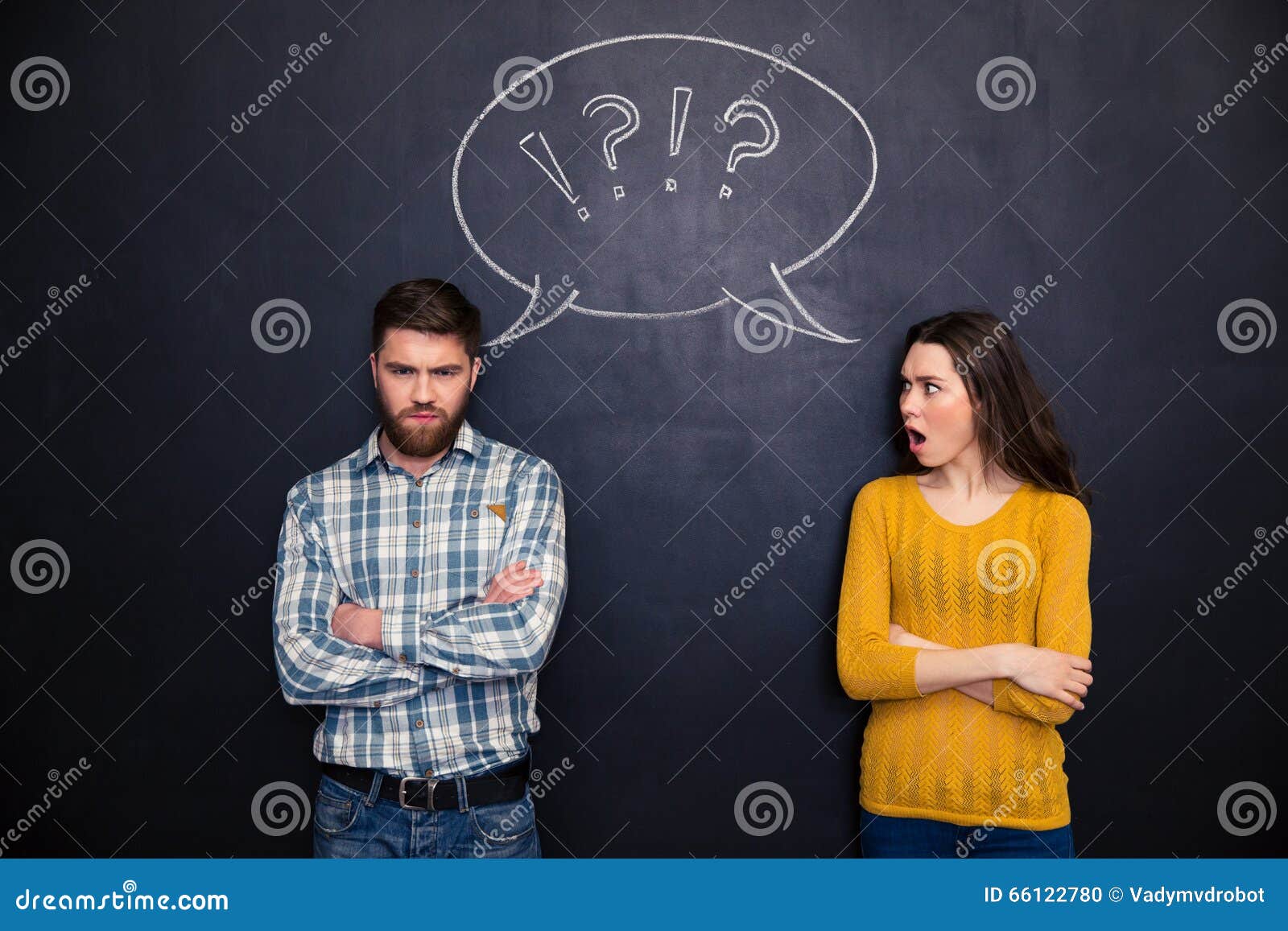 frowning couple standing after argument over chalkboard background