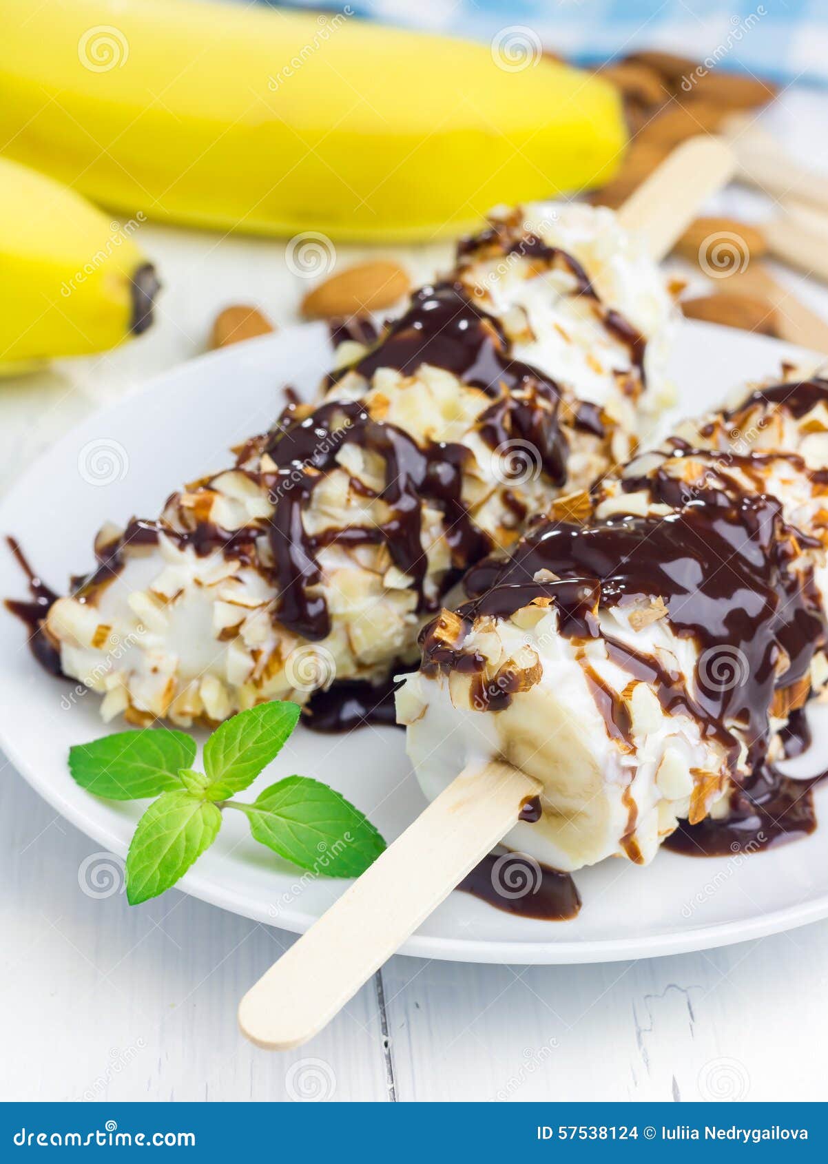 Frozen Banana Covered with Yogurt, Almonds and Chocolate Stock Photo