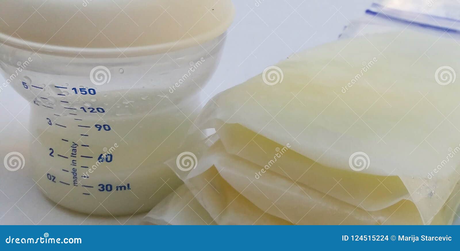 Frozen Breast Milk in Storage Bags and Breast Pump Stock Photo Image