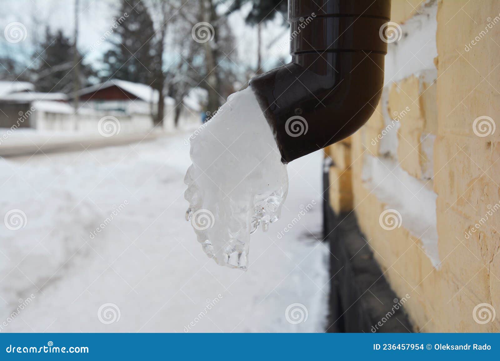 A Frozen Downpipe, Downspout of a Rain Gutter System. Ice or Frozen