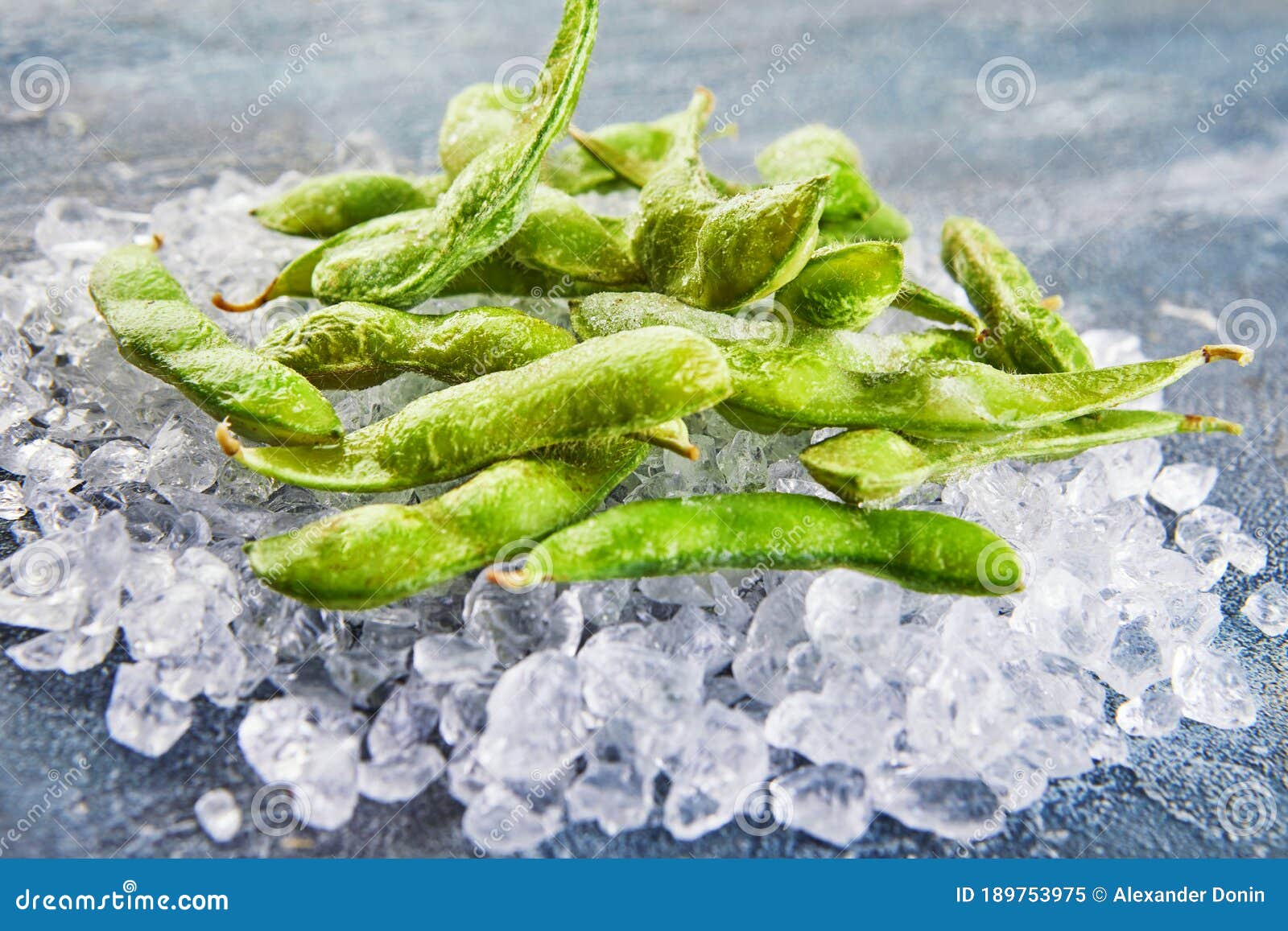 Frozen Edamame or Soybeans in the Mix with Crushed Ice on a Blue