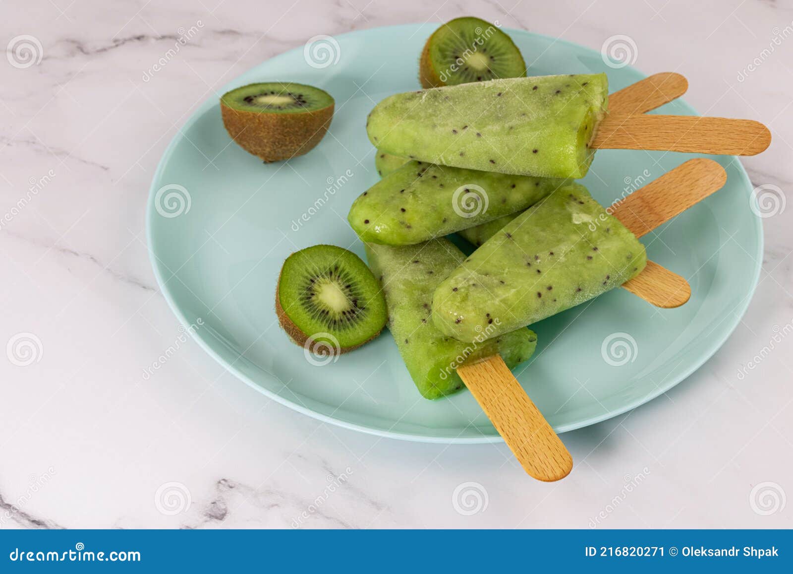Frozen Fruit Kiwi Juice in a Bowl. Refreshing Popsicle on a Stick Stock