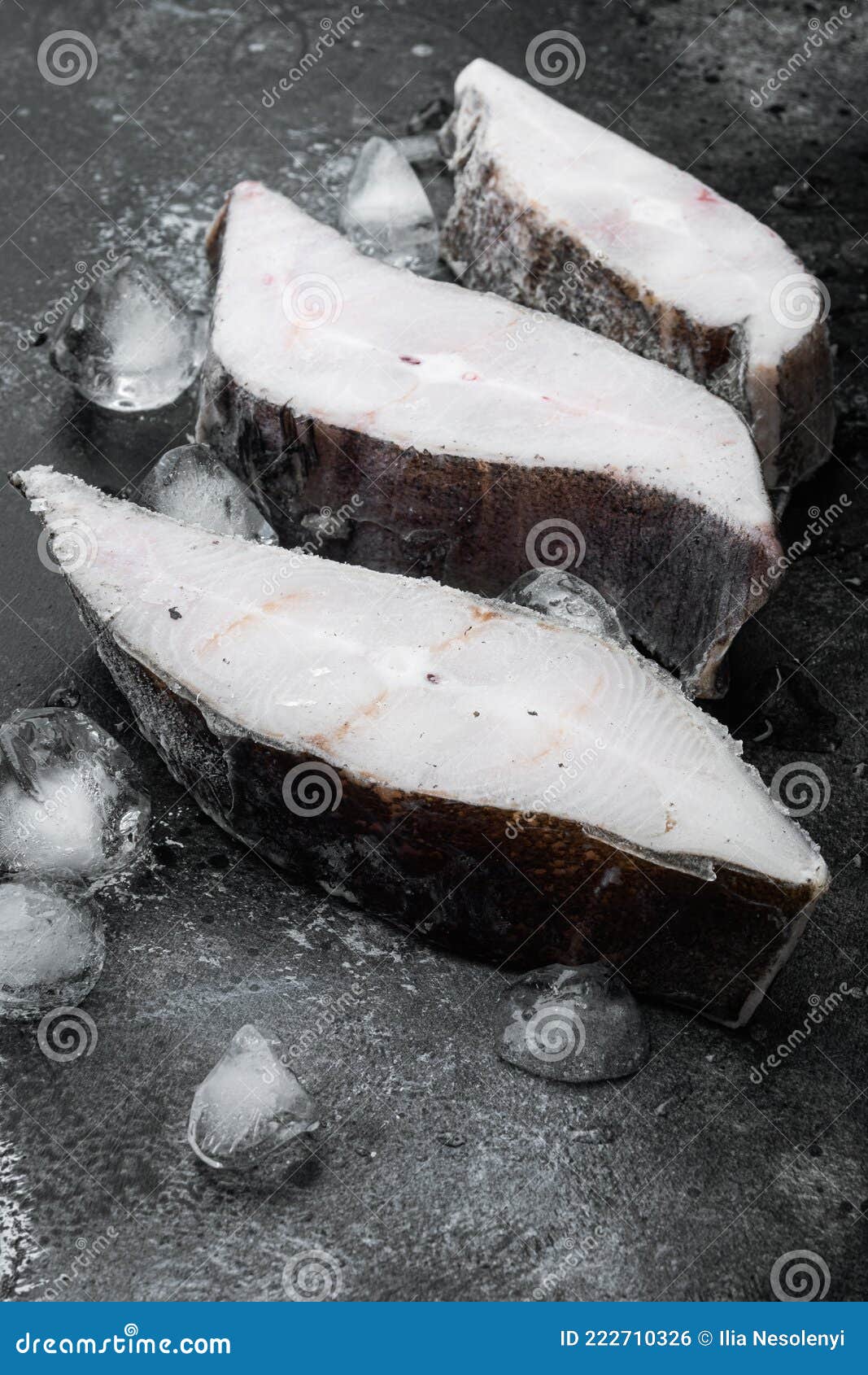 Frozen Halibut Steak, on Black Dark Stone Table Background Stock Photo