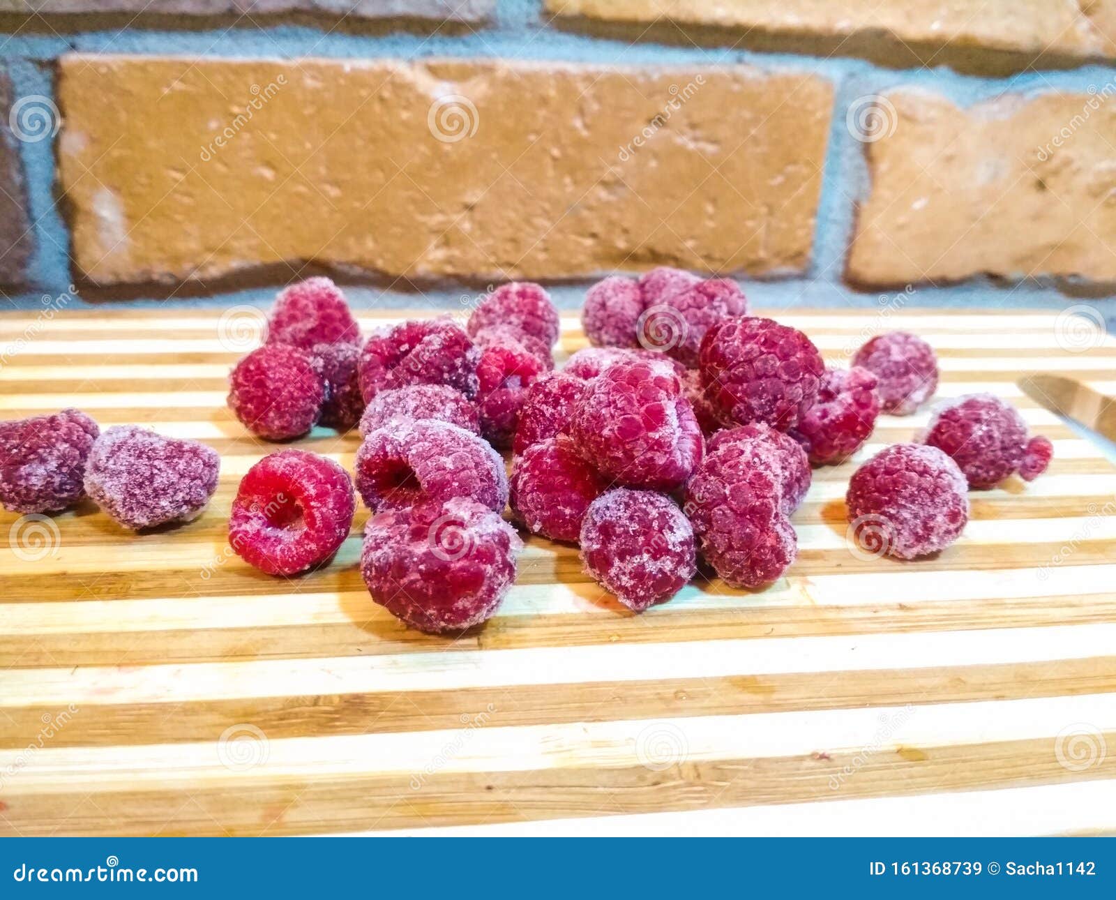 frozen raspberry. close up. frozen raspberries on wooden tables.