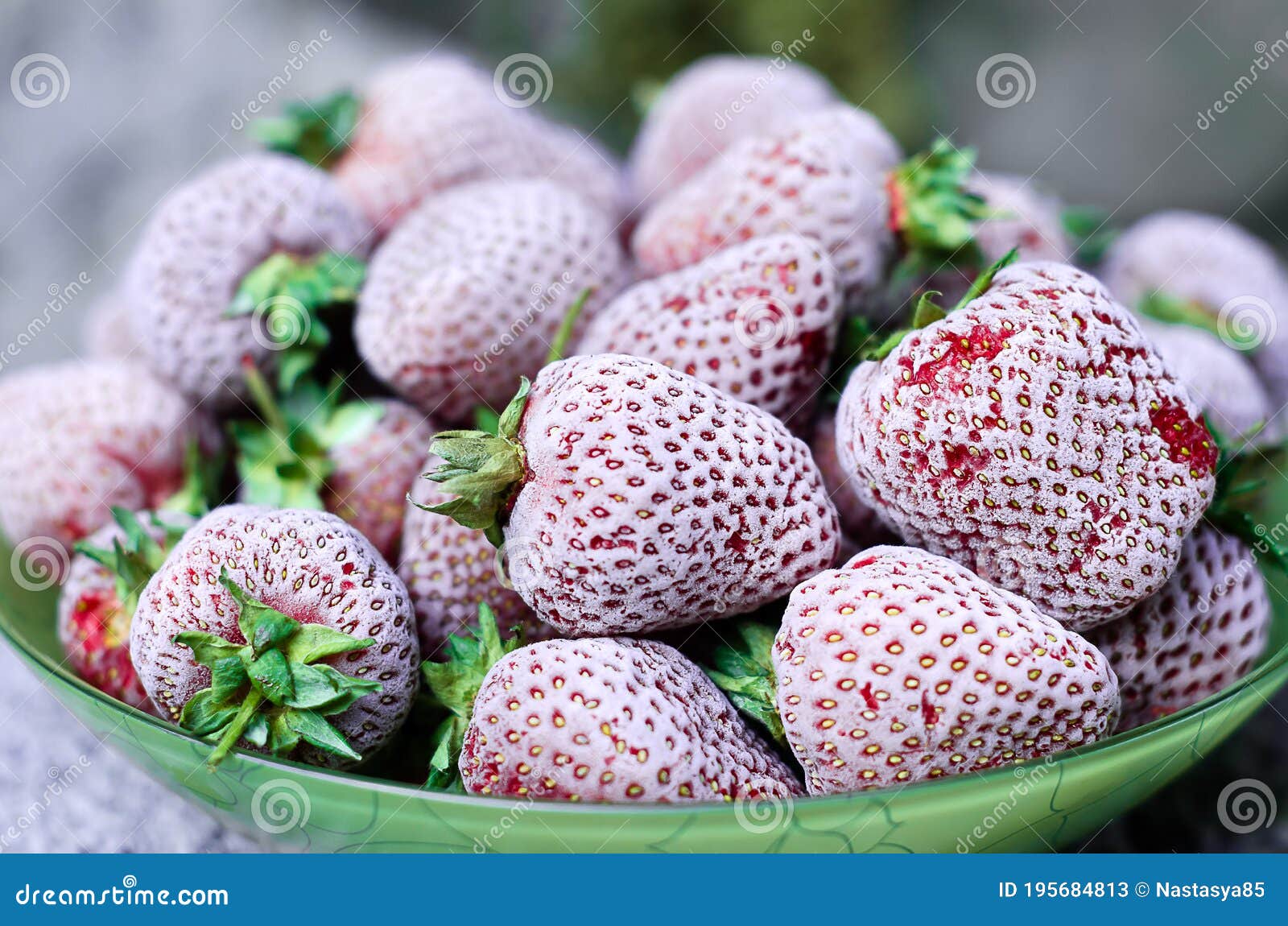 Frozen Strawberries Covered with Hoarfrost on a Plate. Closeup, Side