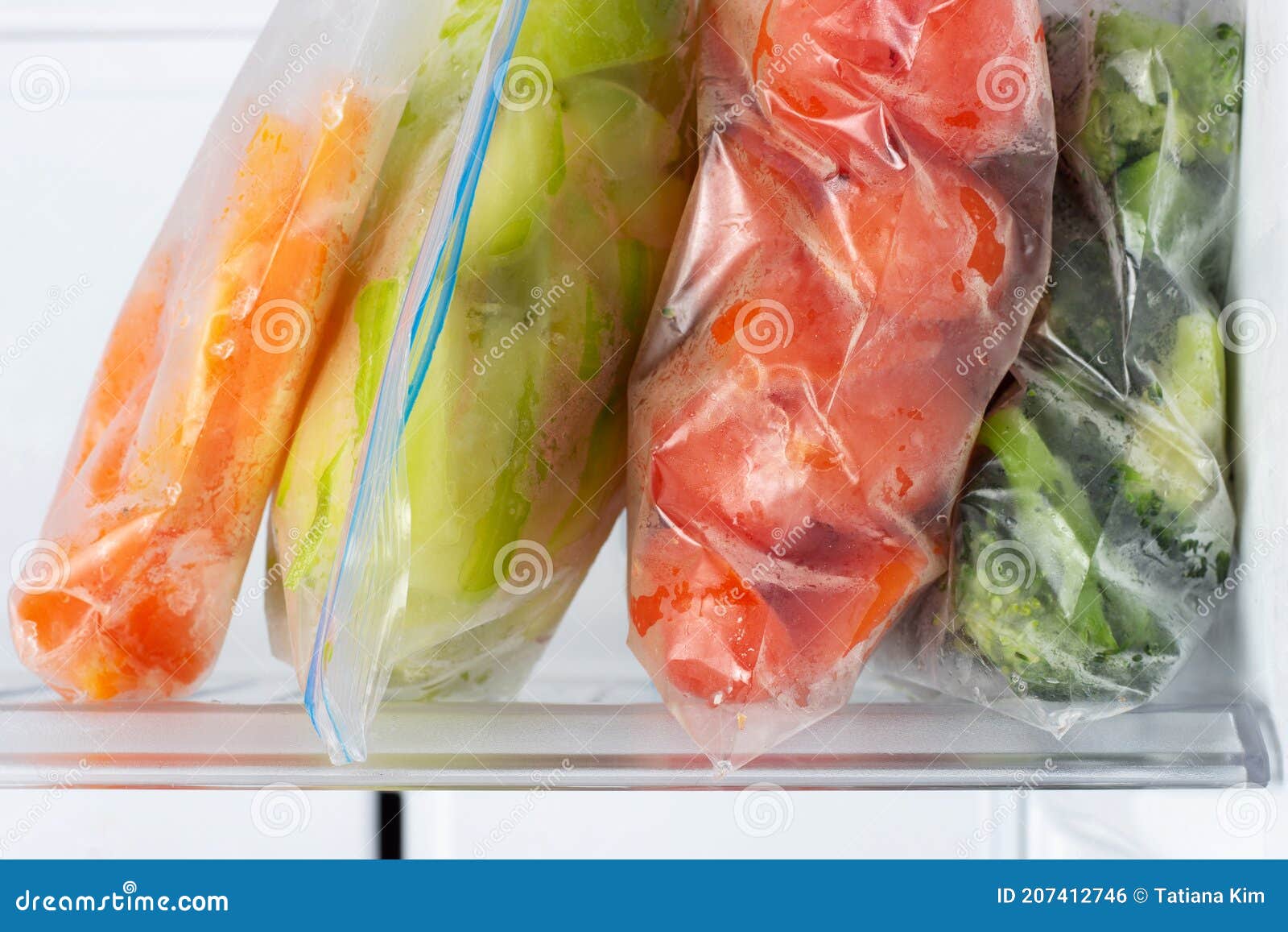 Frozen Vegetables in Plastic Bags in the Freezer Closeup. Stock Photo