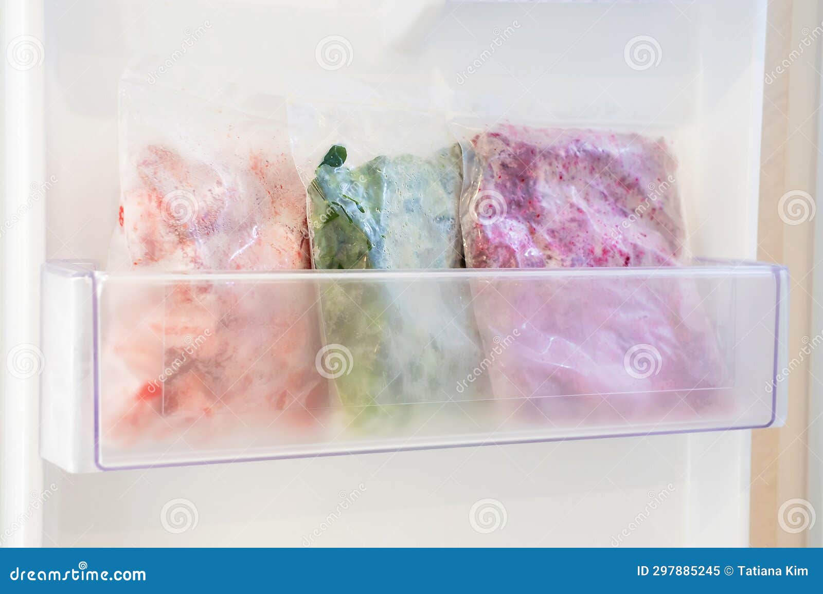 Frozen Vegetables in Plastic Bags in Freezer Closeup, Side View. Stock