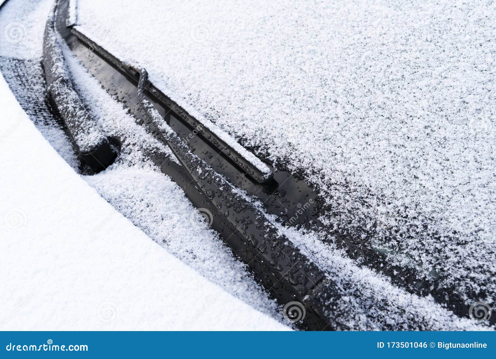 Frozen Windshield Wiper and Glass on Car. Close Up Frozen Windshield