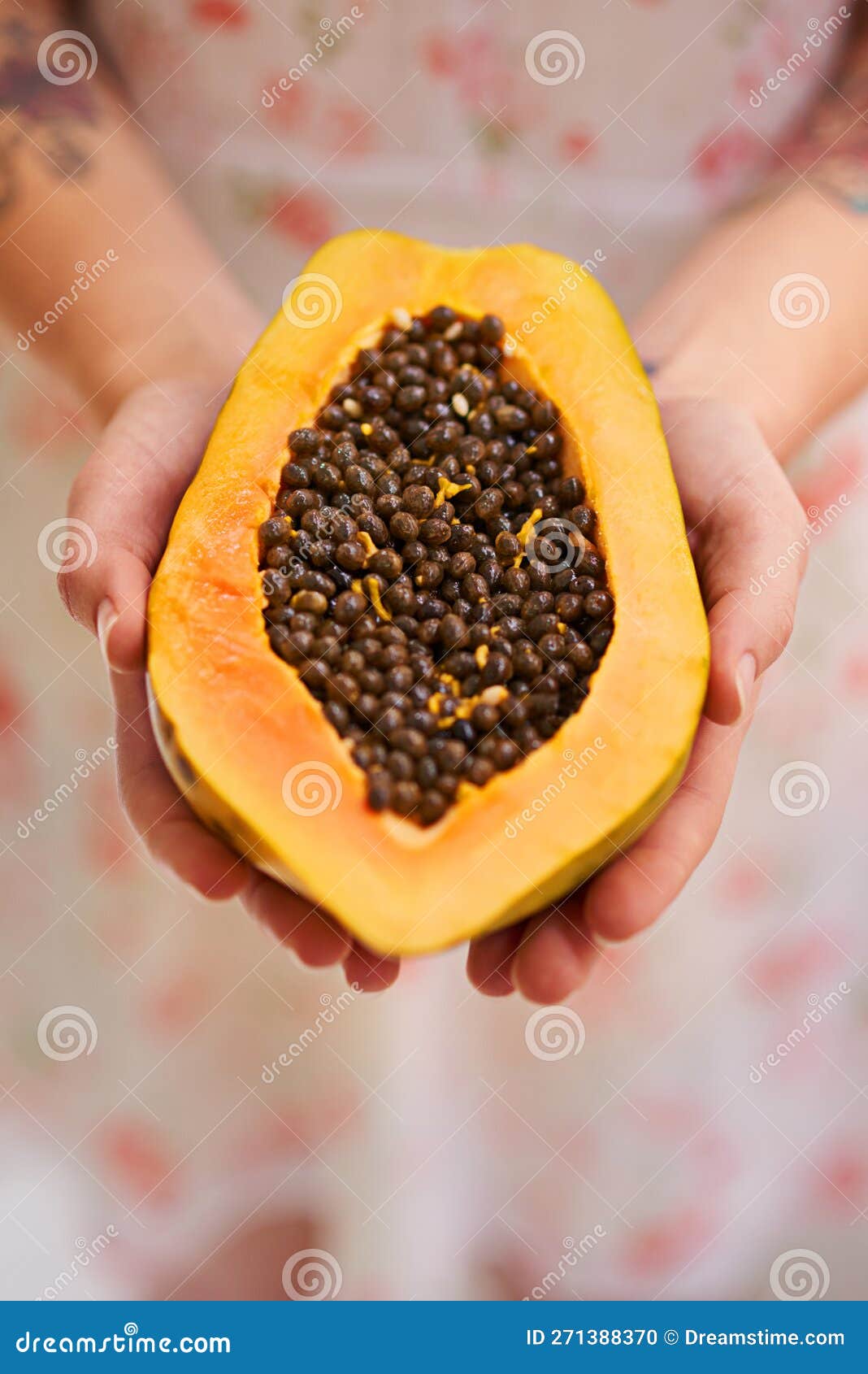 Fruit of the Angels. Half a Papaya in a Persons Hands. Stock Photo