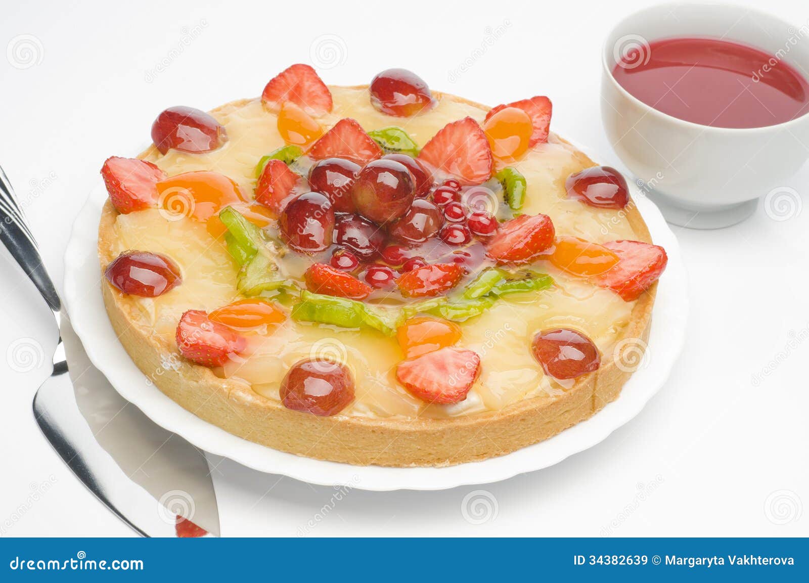 Fruit cake on a plate with tea over white background