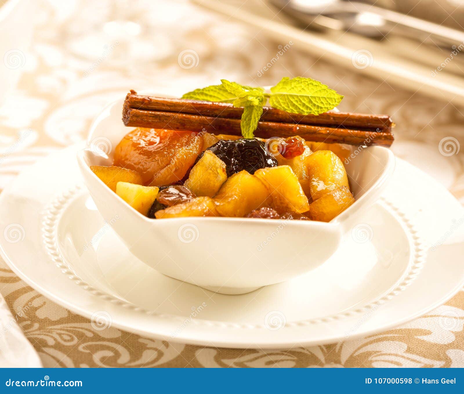 Fruit Compote in a Bowl on a Christmas Dinner Table. Stock Photo