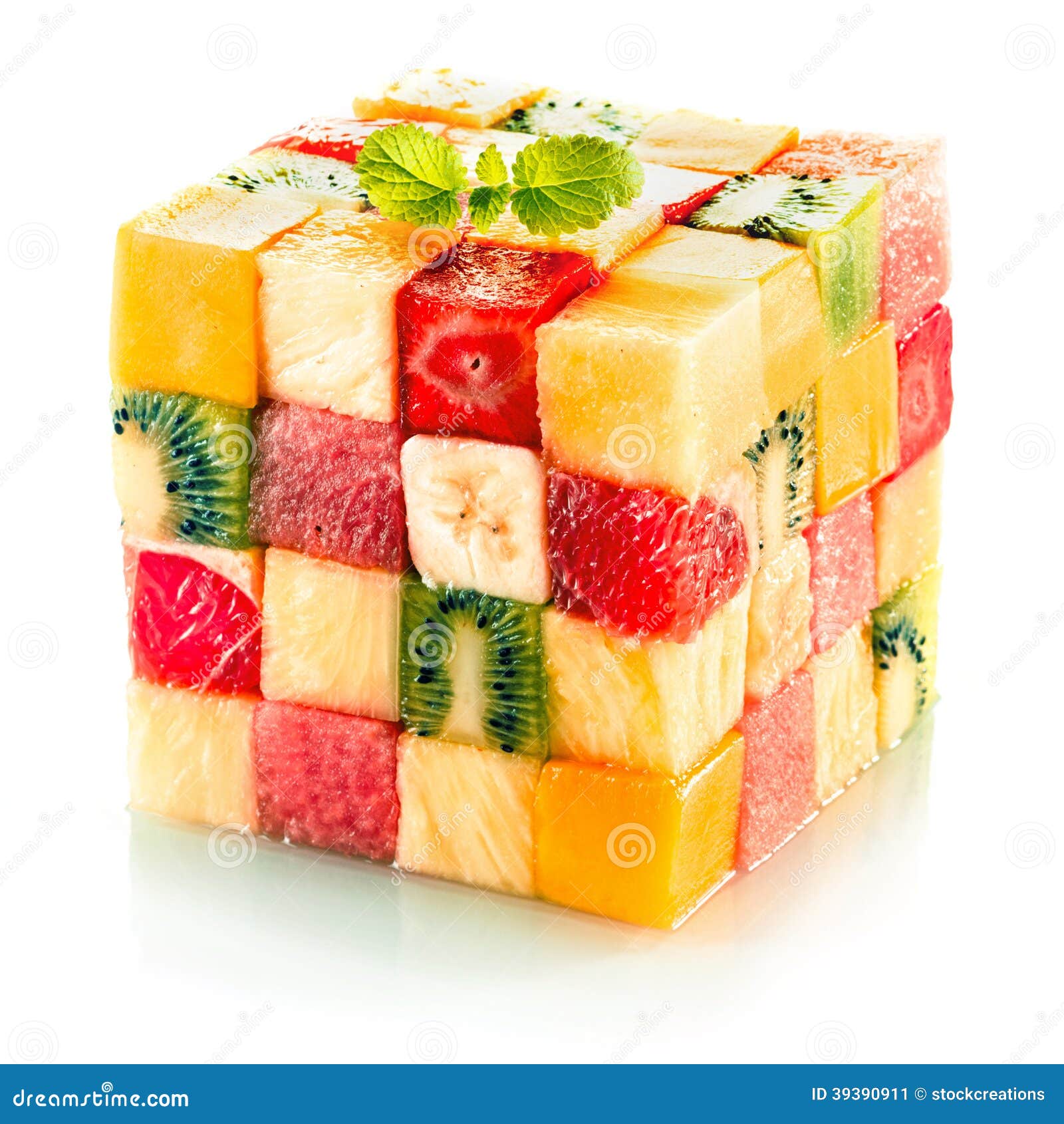 Fruit cube with assorted tropical fruit. Fruit cube formed from small squares of assorted tropical fruit in a colorful arrangement including kiwifruit, strawberry, orange, banana and pineapple on a white background