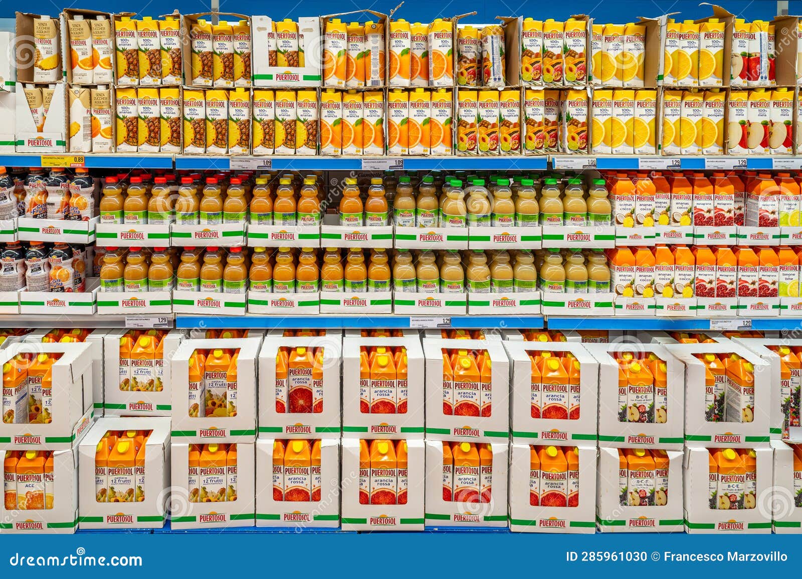 Fruit Juices in Plastic Bottles and in Cartons Displayed on Shelves