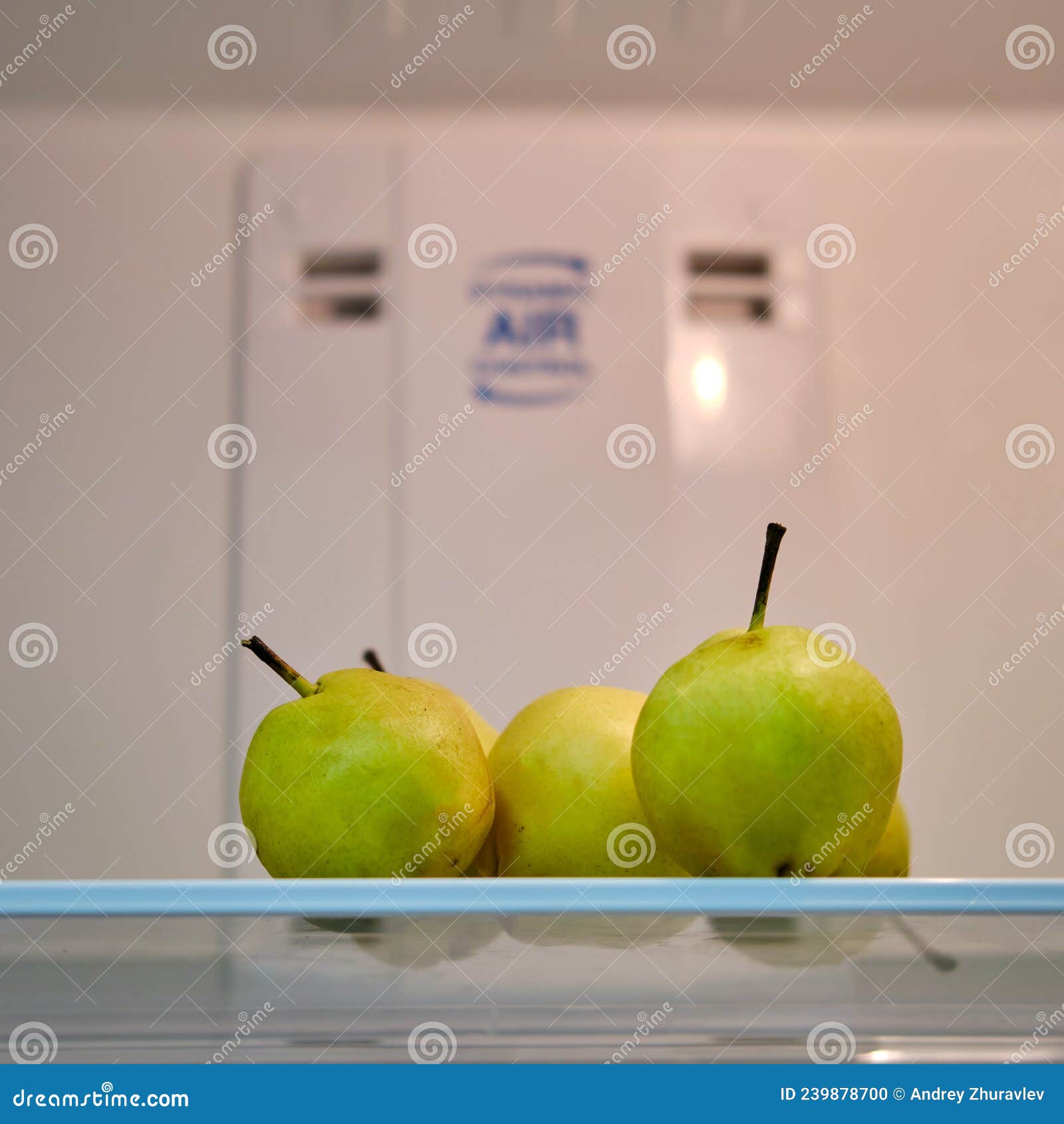 Fruit Pears on a Shelf in an Empty White Refrigerator Stock Photo