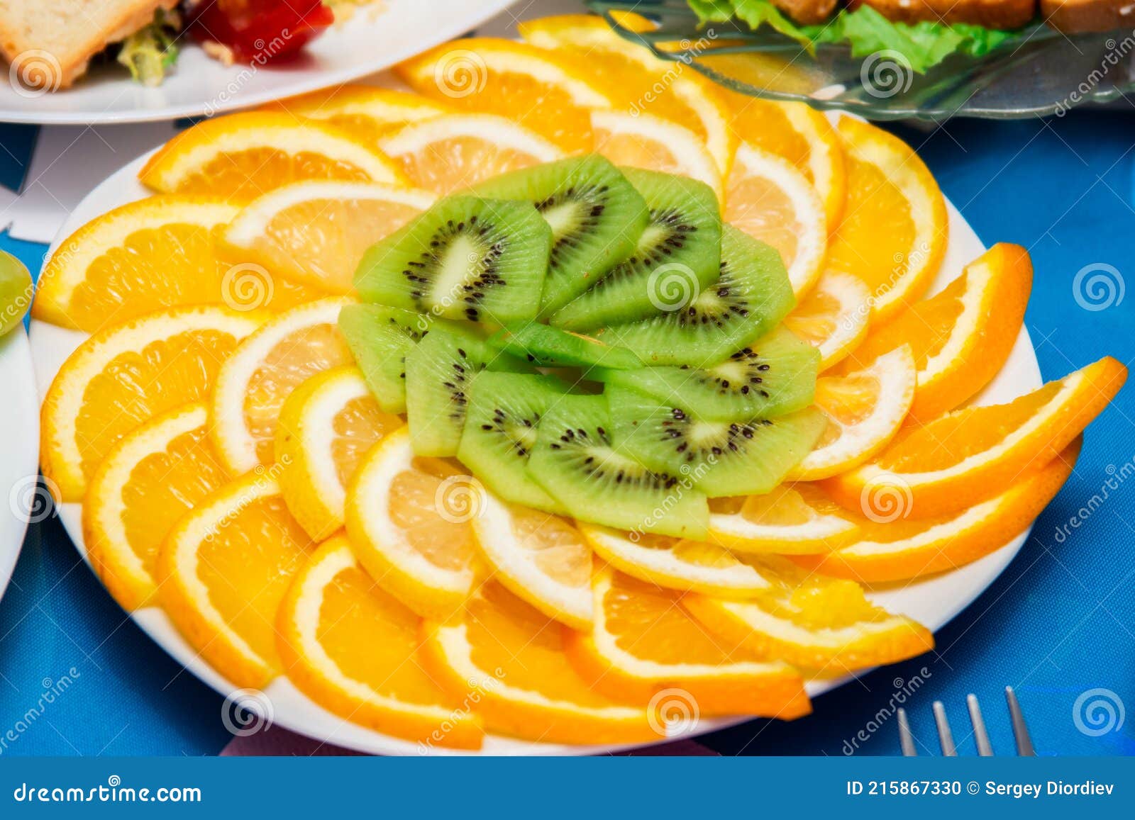 fruit salad. oranges and kiwi slices laid out on a plate. sweet dessert.