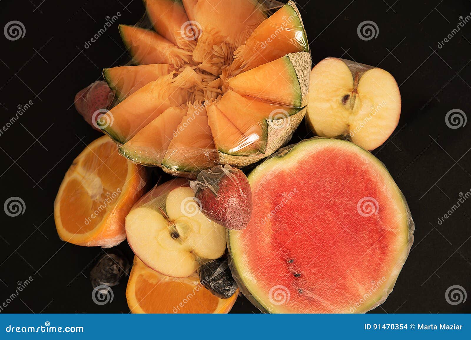 Fruits Packed in Plastic Film on Black Background Stock Photo Image