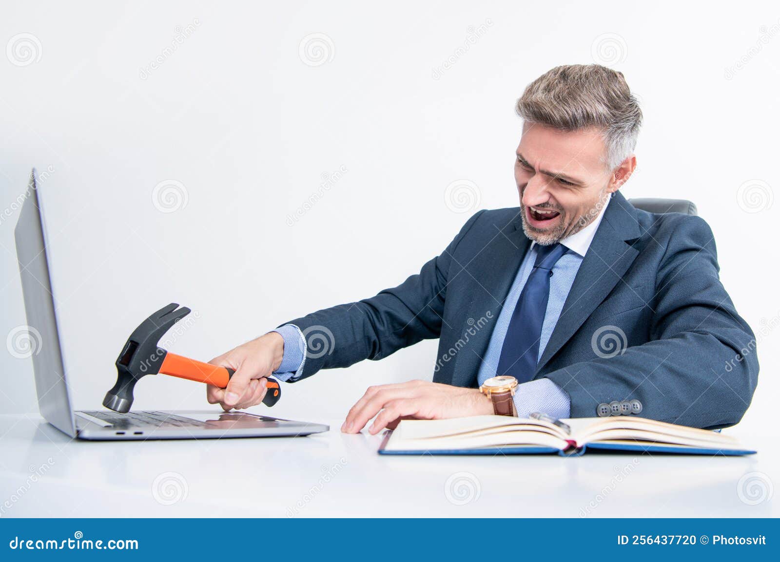 Frustrated Boss Hitting Computer with Hammer in Office Stock Photo