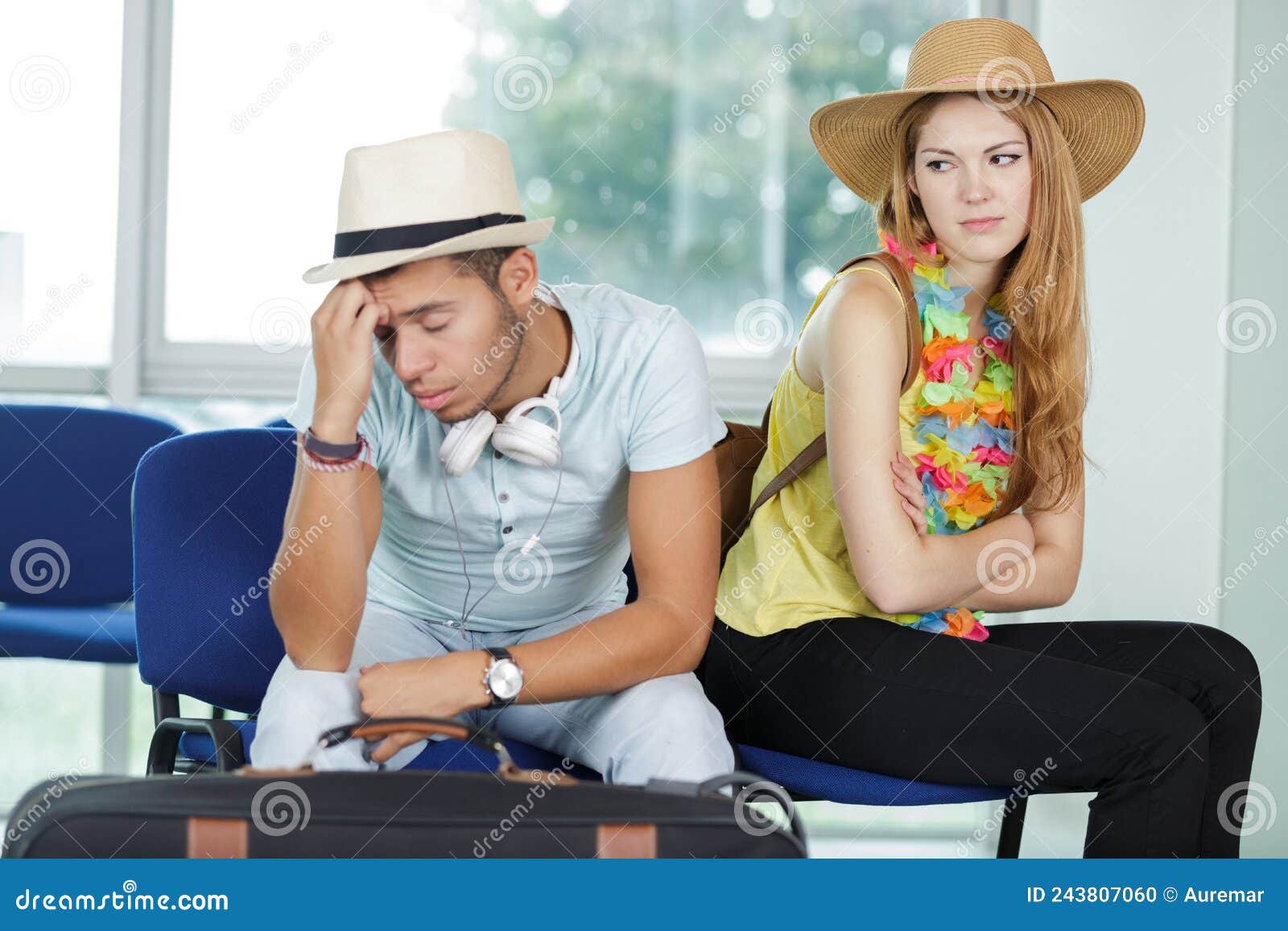 frustrated couple waiting in airport lounge