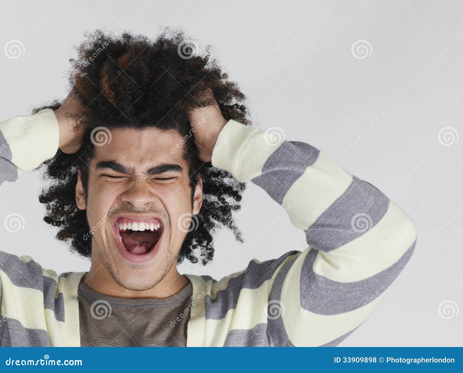 frustrated man with afro hairdo pulling hair