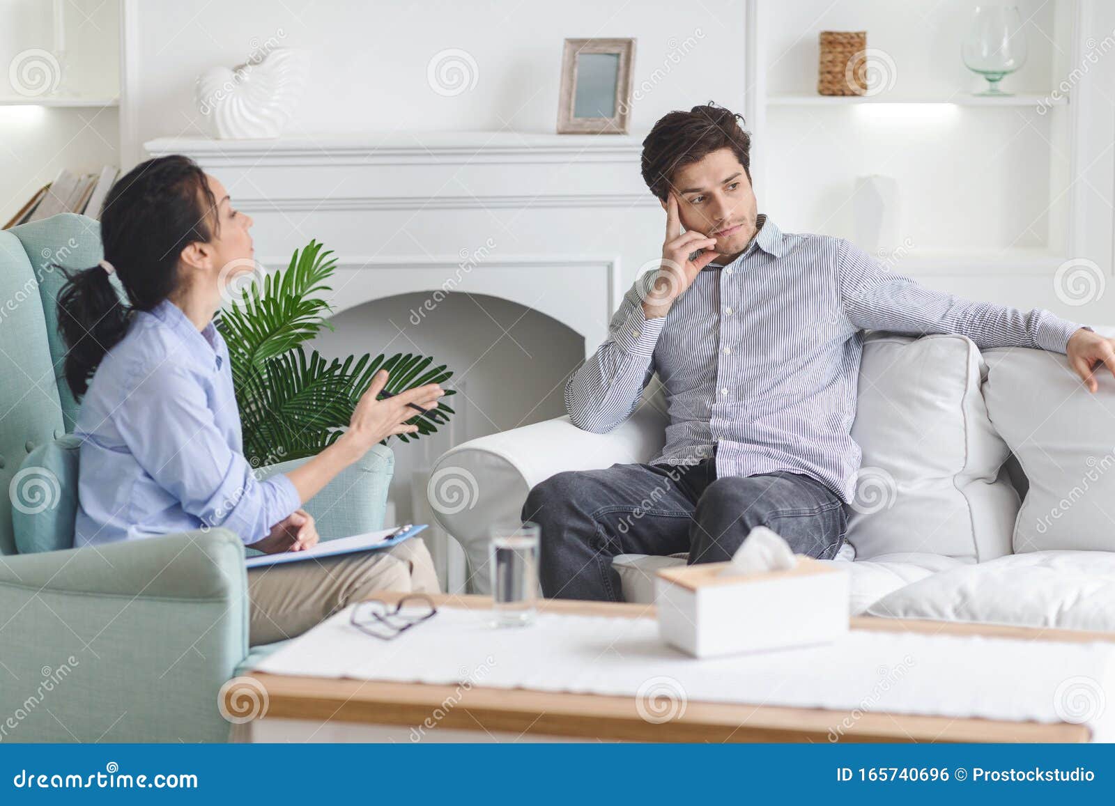Frustrated Guy Sitting On Sofa At Psychotherapist Private Office Stock