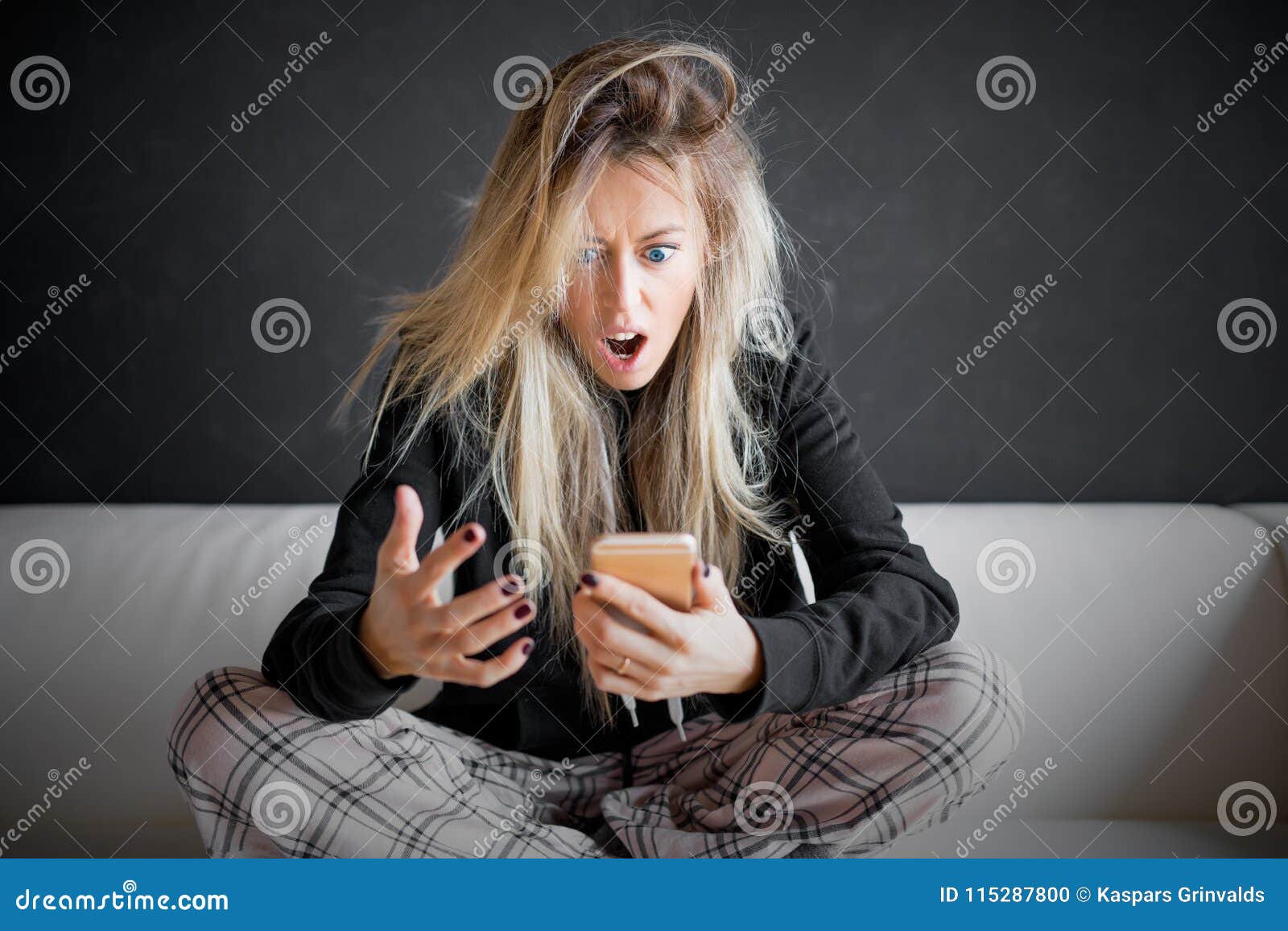 frustrated woman looking at her phone
