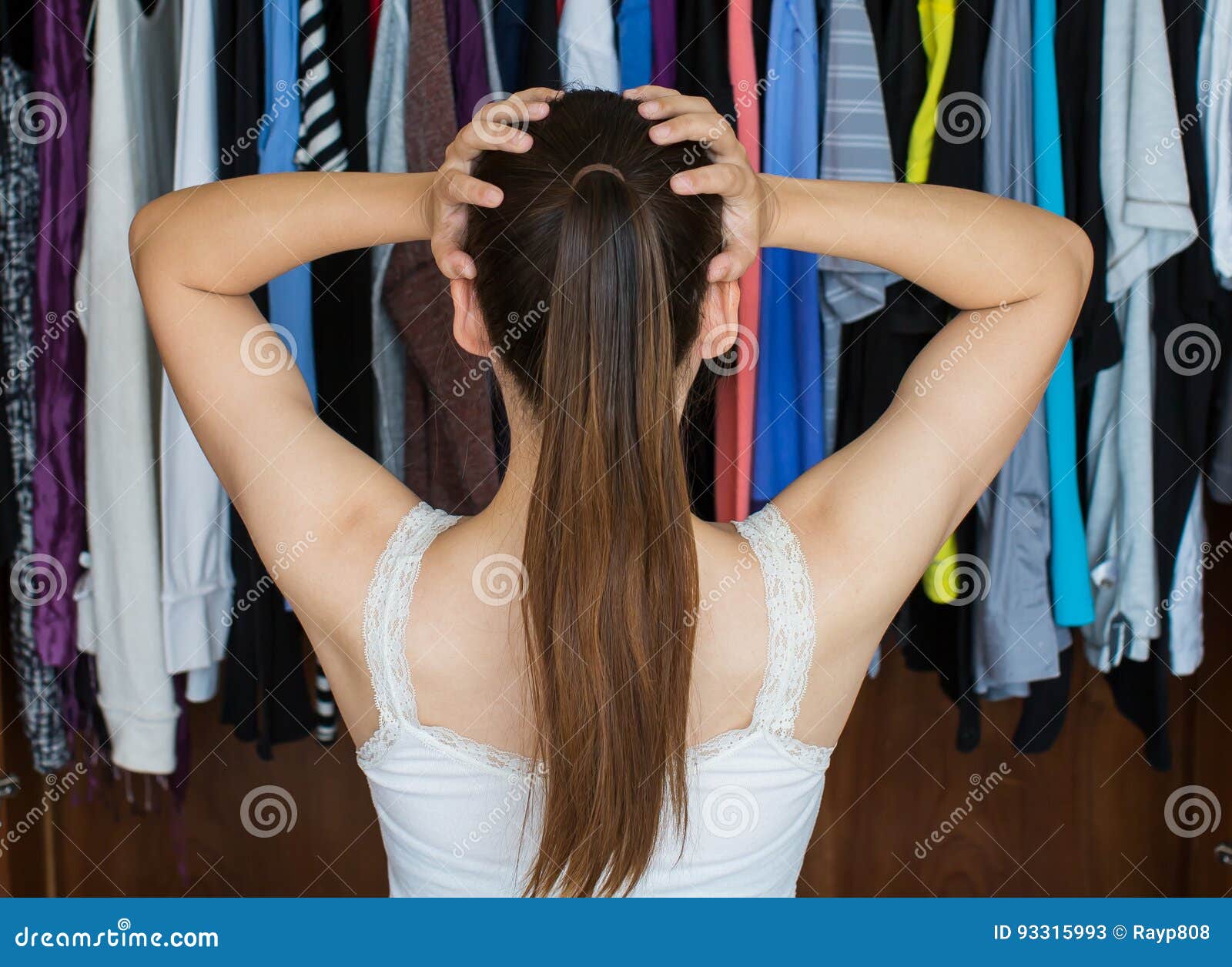 frustrated young woman cannot decide what to wear from her close