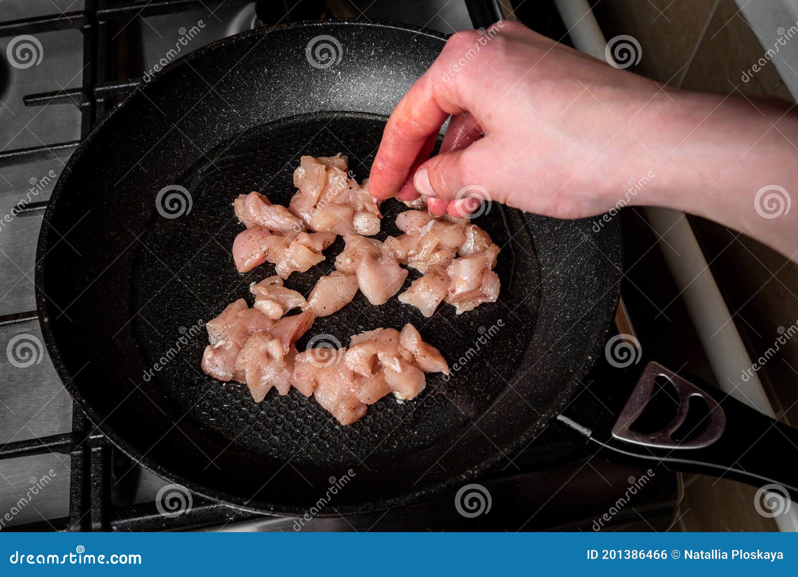 Frying Chicken Meat Cubes in a Pan on Stove. Stock Photo Image of